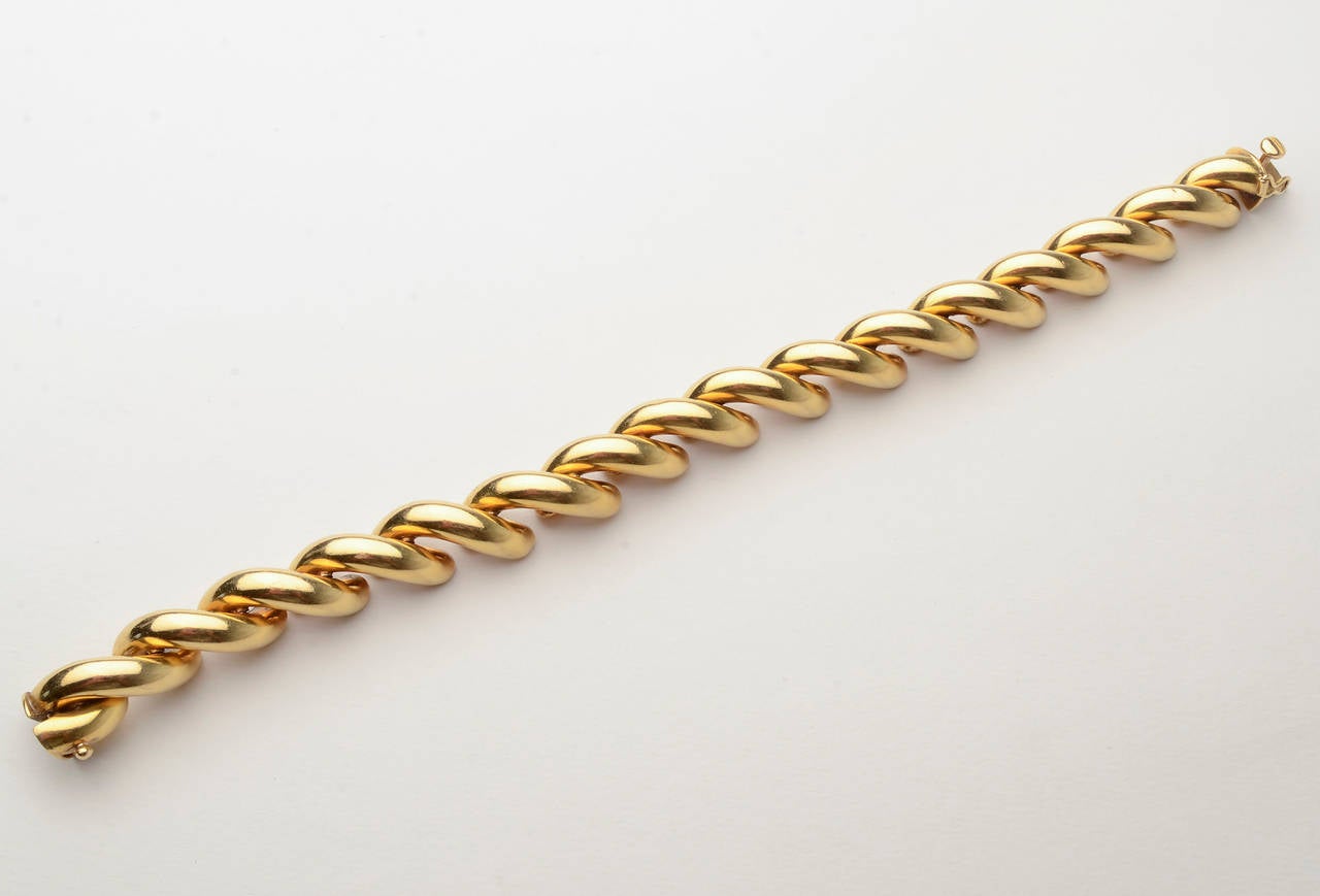 Classic San Marco bracelet in 18 karat gold. Beautiful condition with a secure clasp and safety. Glossy finish;  measures 7 5/8
