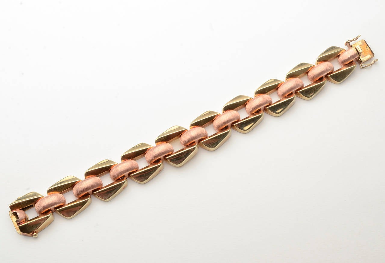 This Retro bracelet is unusual in two aspects. The raised off square links are not often seen. In addition, one doesn't usually find two different finishes in Retro bracelets. In this example, the yellow gold is smooth and the pink gold is satin.