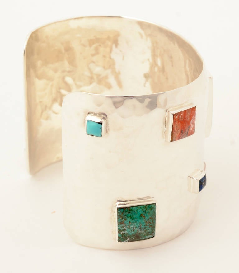 This wide silver cuff by Emilia Castillo is from her Confetti series. It is scattered with square stones of various sizes. The largest is malachite with turquoise; lapis lazuli; and agate. This colorful and playful bracelet can be worn well with