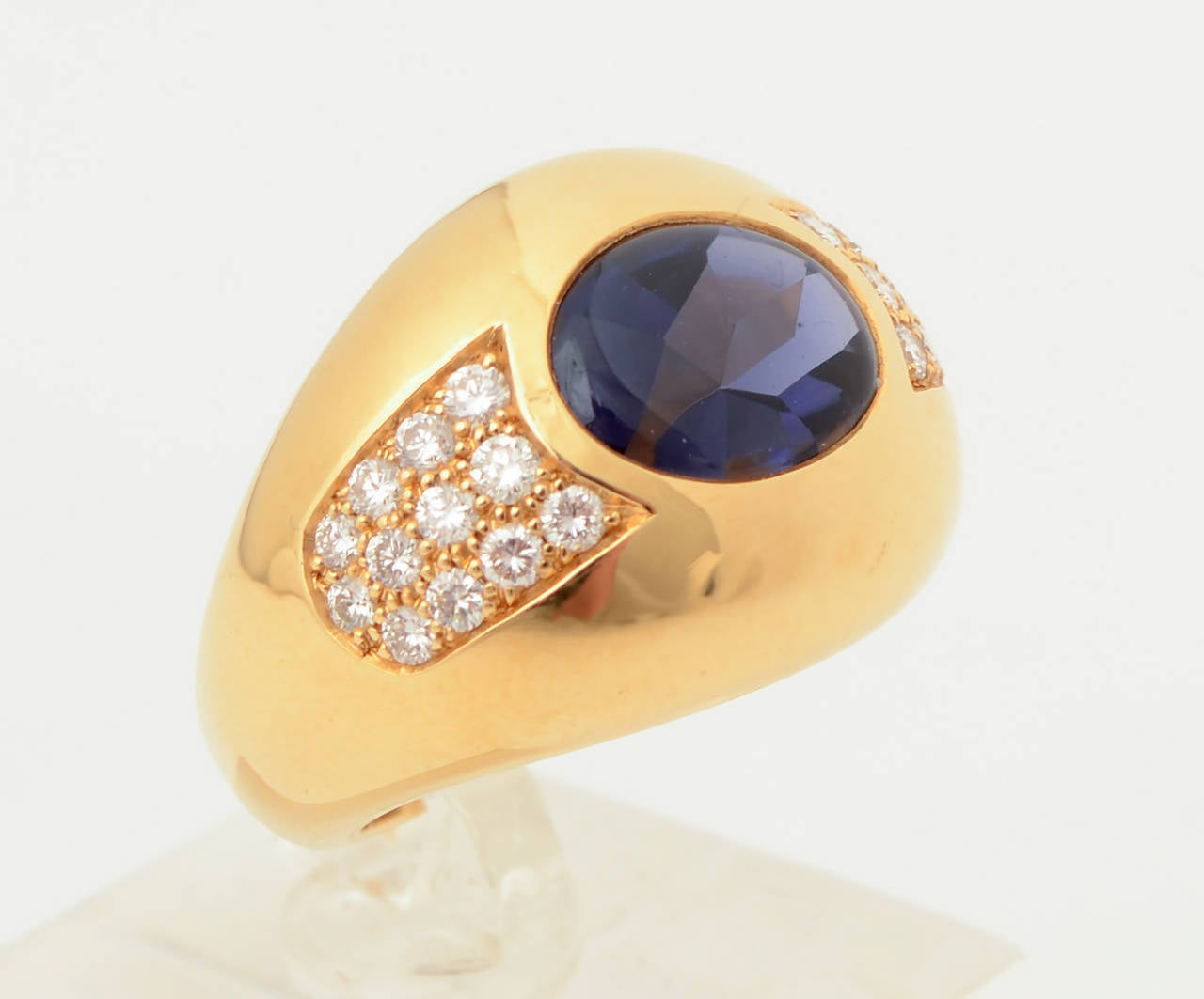 This elegant Mauboussin ring is centered with a richly colored iolite surrounded by diamonds. Ring is size 4 1/2 but can be sized up or down. The front is 11/16