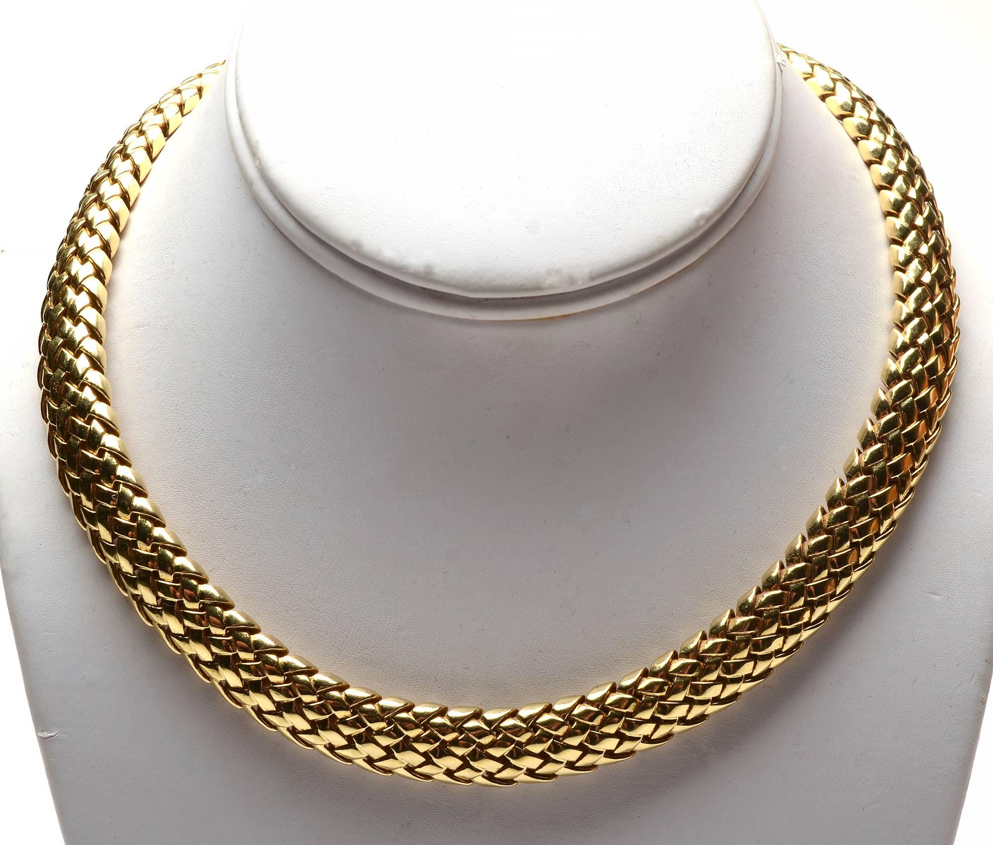 This is a substantial, timeless 18 karat gold choker necklace by Tiffany and Co. The woven width is half an inch and 16 1/4
