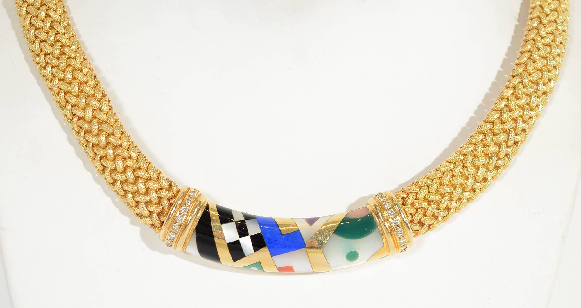 This woven 14 karat gold choker necklace by Asch Grossbardt is embellished front and back with hardstone plaques of abstract designs.
The front panel measures 2 3/8