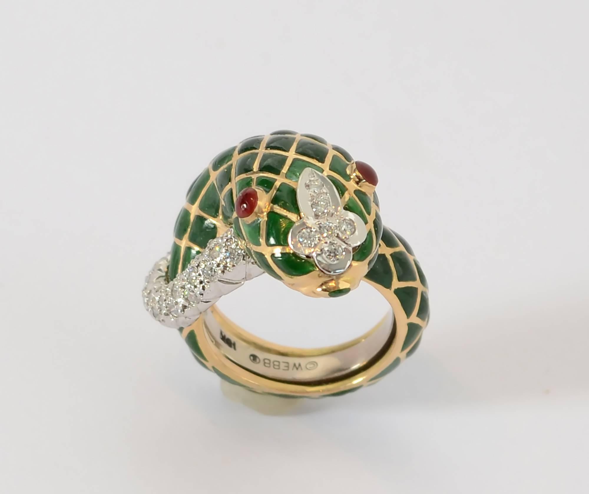 Coiled snake ring by David Webb. The body is green enamel with pave set diamond face and tail. Eyes are rubies. The ring is finger size 6 1/2; excellent condition.
The top of the ring measures 1