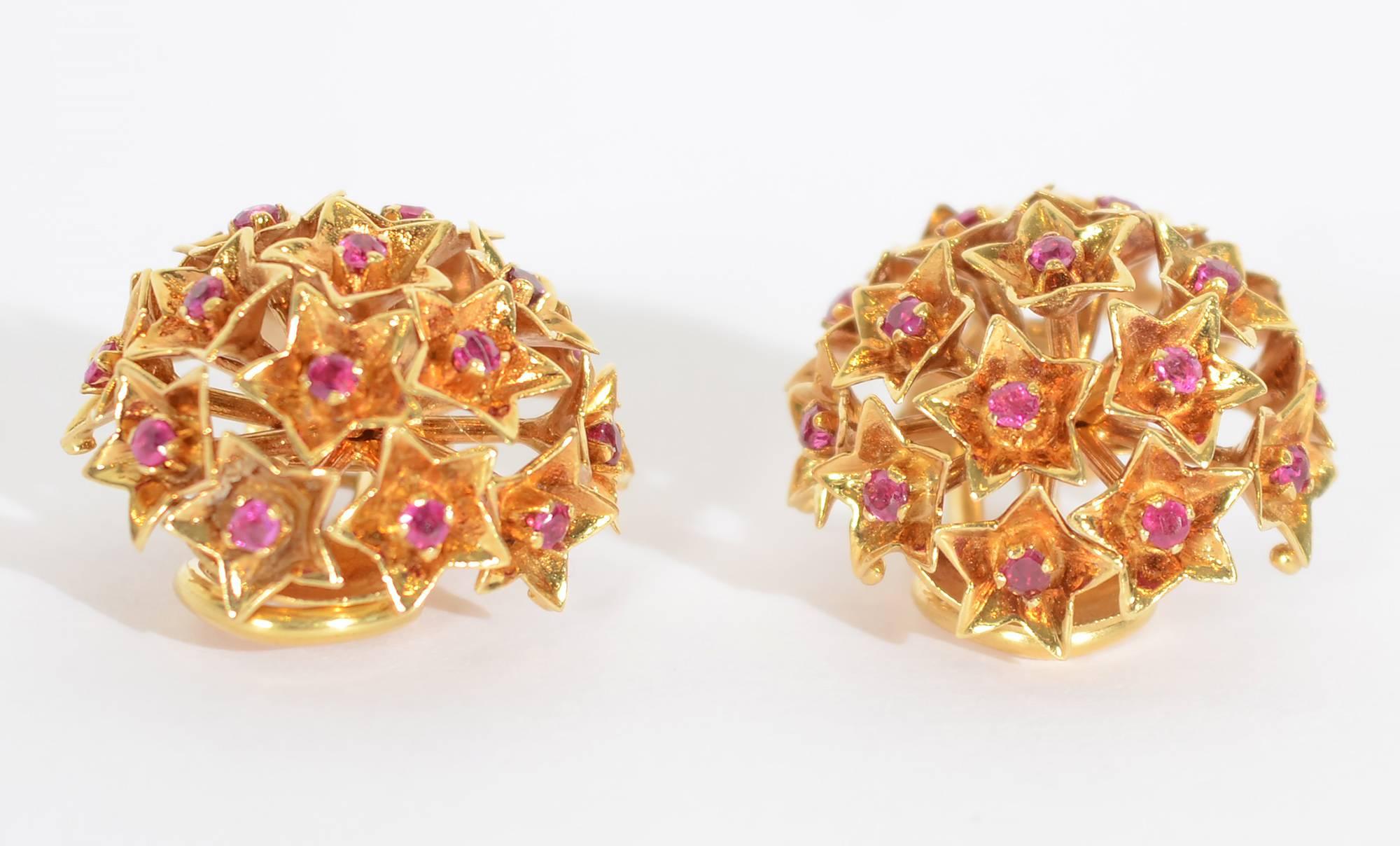 Dome shaped earrings by Tiffany and Co. in which rubies are set in five point stars. They measure 3/4