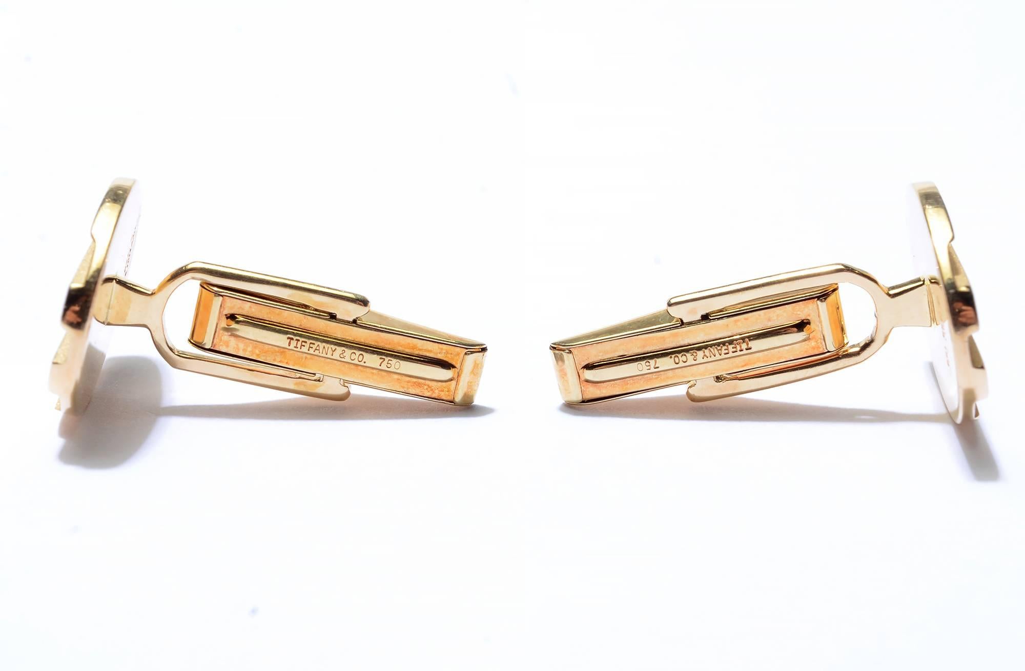 Tailored eighteen karat gold cufflinks by Tiffany & Co. They have two different finishes. The raised bars have a glossy finish and the lower areas have a finely granulated surface. Measurements are 3/4