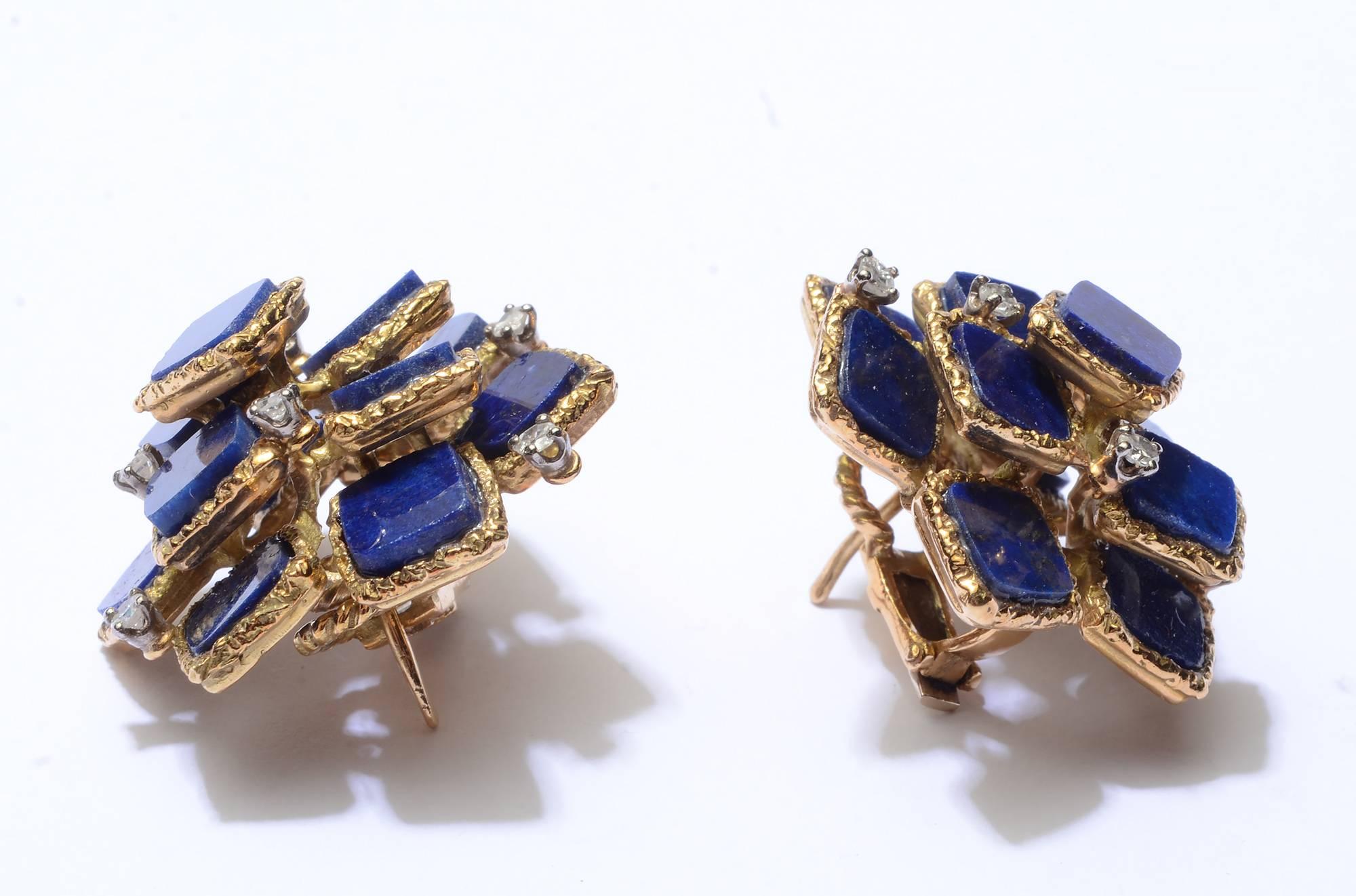 Eleven squares of lapis lazuli are set in a multi tiered arrangement in these earrings by J. Rossi. Each lapis stone is set in a textured gold band. Six diamonds weighing .05 carats each are set in each earring. Backs are posts and clips.
Matching