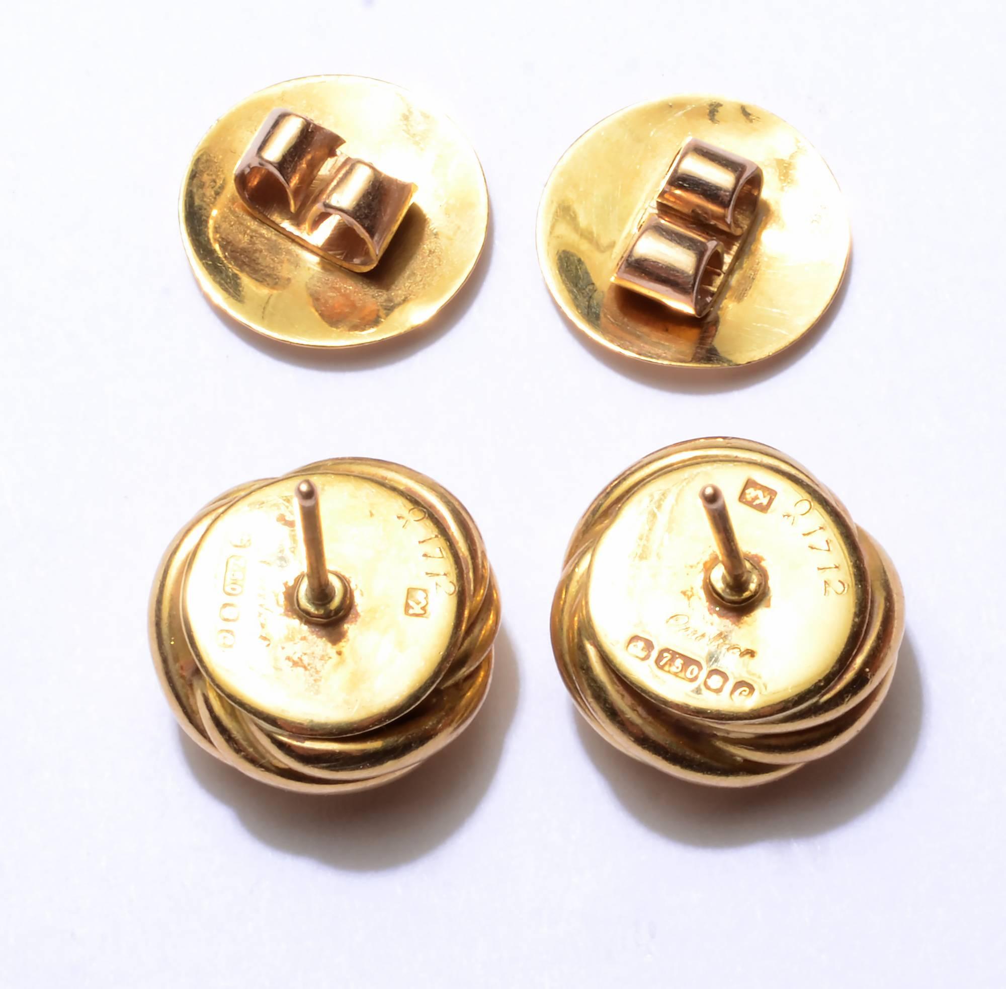 Classic Cartier love knot earrings with a triple swirl of 18 karat gold. They have post backs and European assay marks. They measure 1/2