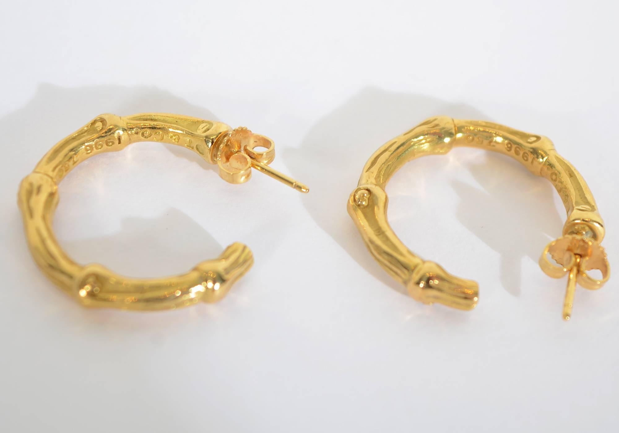 The bamboo style hoop earrings by Tiffany are the perfect everyday earrings. The nice texturing makes them more interesting than standard hoops. Nice weight makes them feel solid without being too heavy to be comfortable. Made of 18 karat gold. They