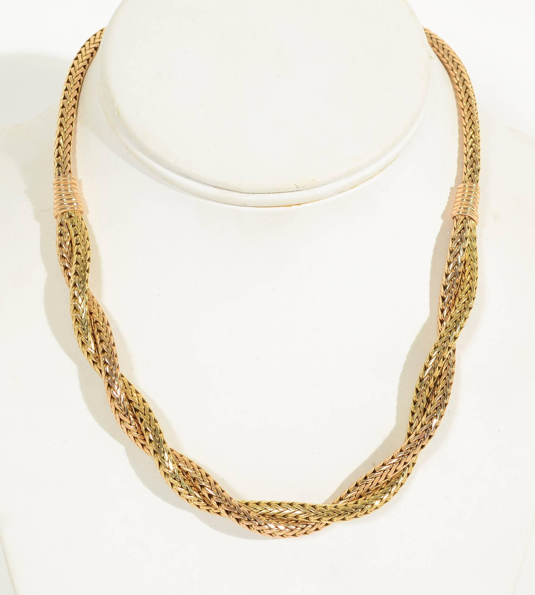 Unusual Retro necklace of pink and yellow gold in a herringbone pattern. The central panel intertwines both colors while the banding and part behind the neck are pink. The difference in the two colors is subtle but evident. The necklace measures 16