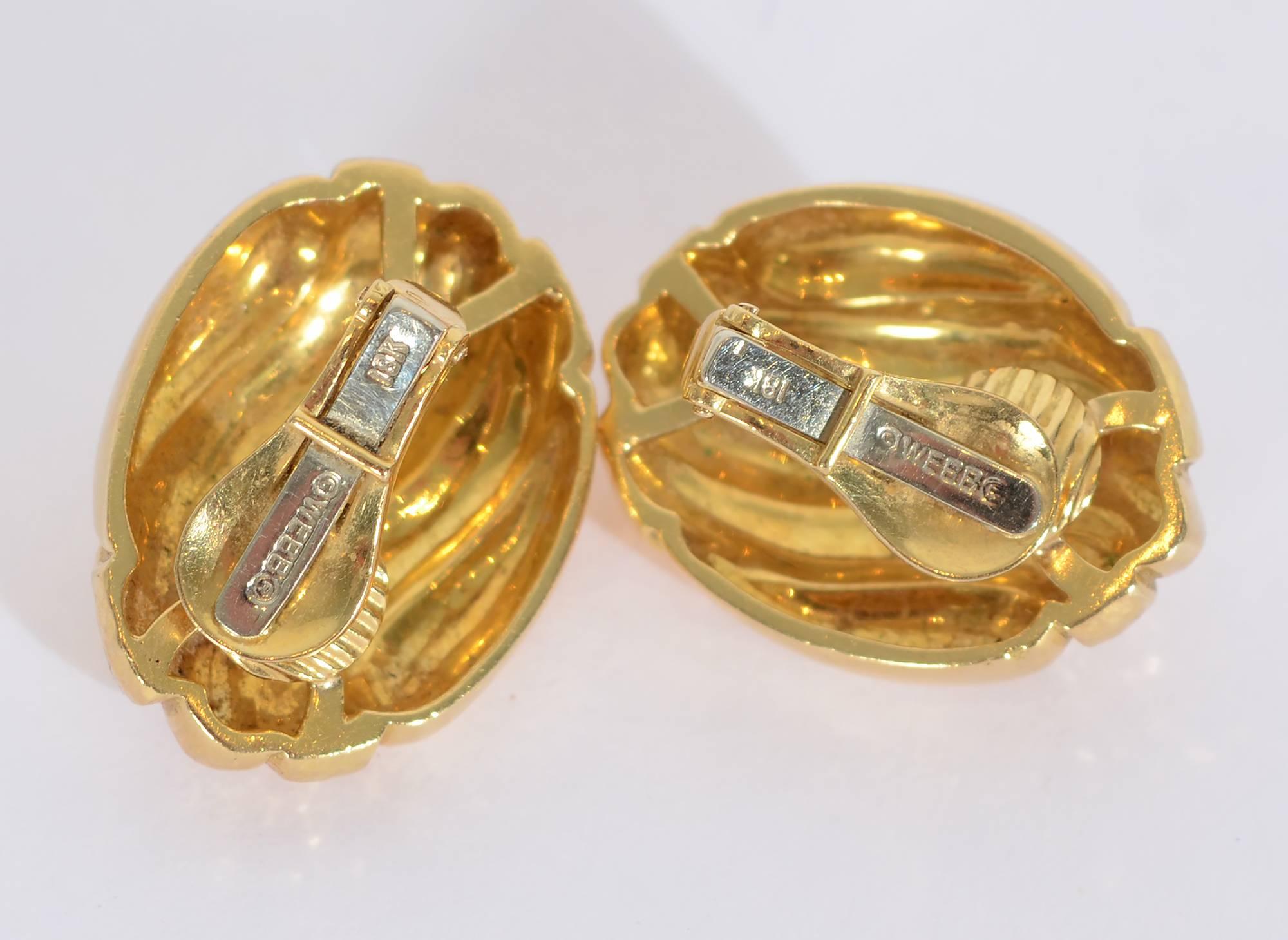 arge 18 karat gold earrings by David Webb. Alternate swirls of hammered and glossy textures  complement the oval shape of the earrings.  Clip backs can be converted to posts.