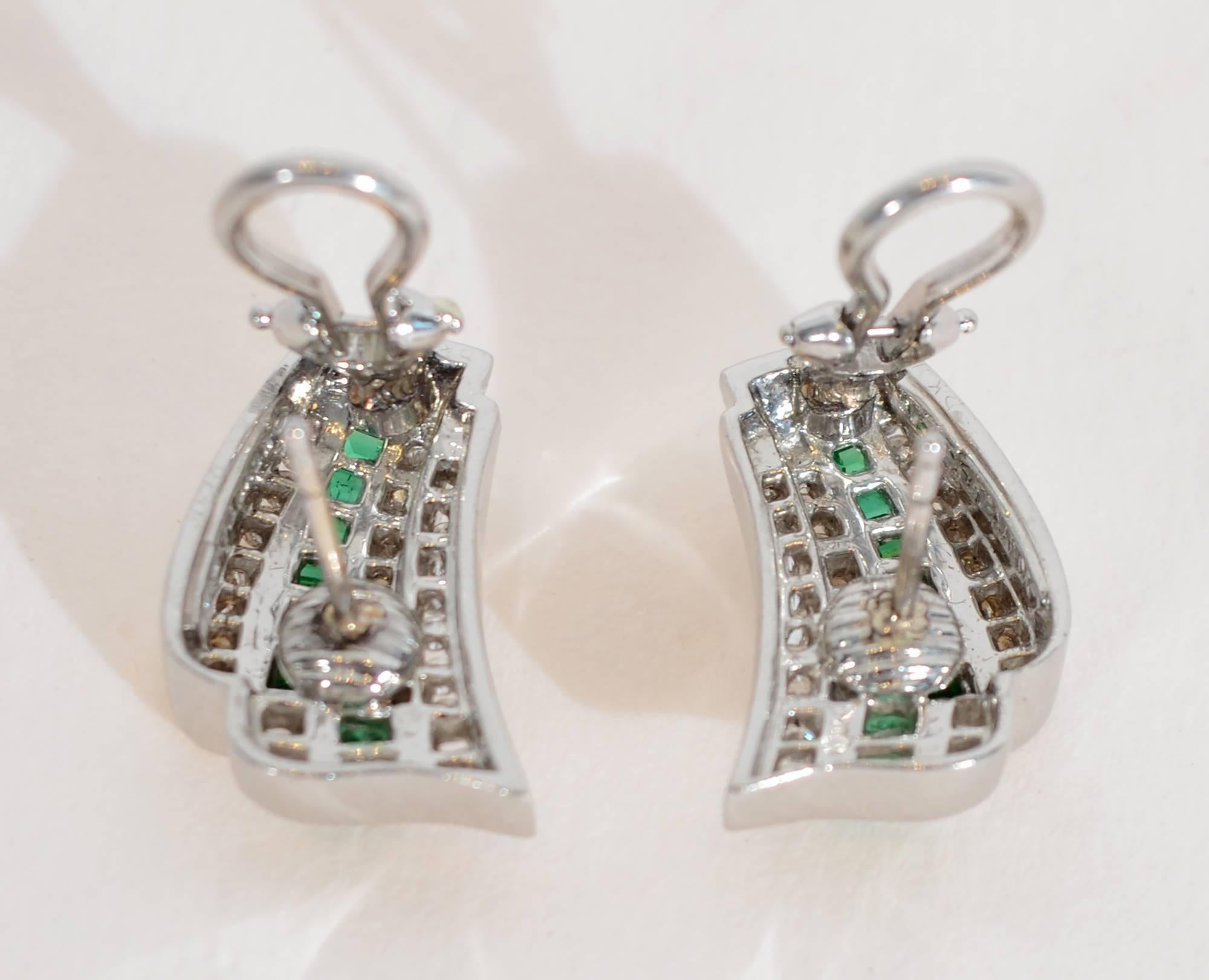 Classic and elegant diamond and emerald earrings by New York jeweler, Charles Krypell. Channel set baguette cut emeralds are surrounded  by round diamonds on either side. The  earrings are made of platinum. They are 3/4