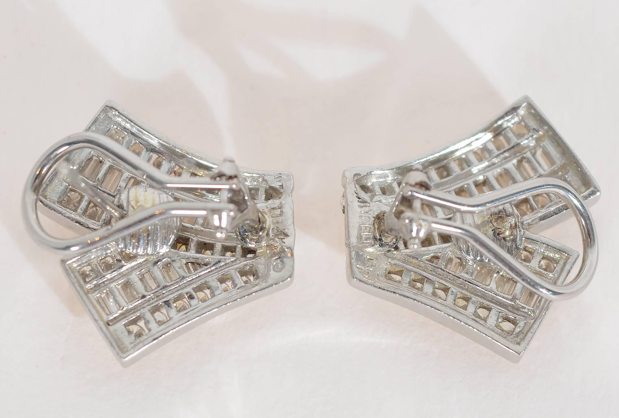 Elegant diamond earrings set in 18 karat white gold by Charles Krypell. The diamonds are baguettes and round of VS-2 quality. Post and clip backs. Measurements are 3/4" tall and 3/4" wide.