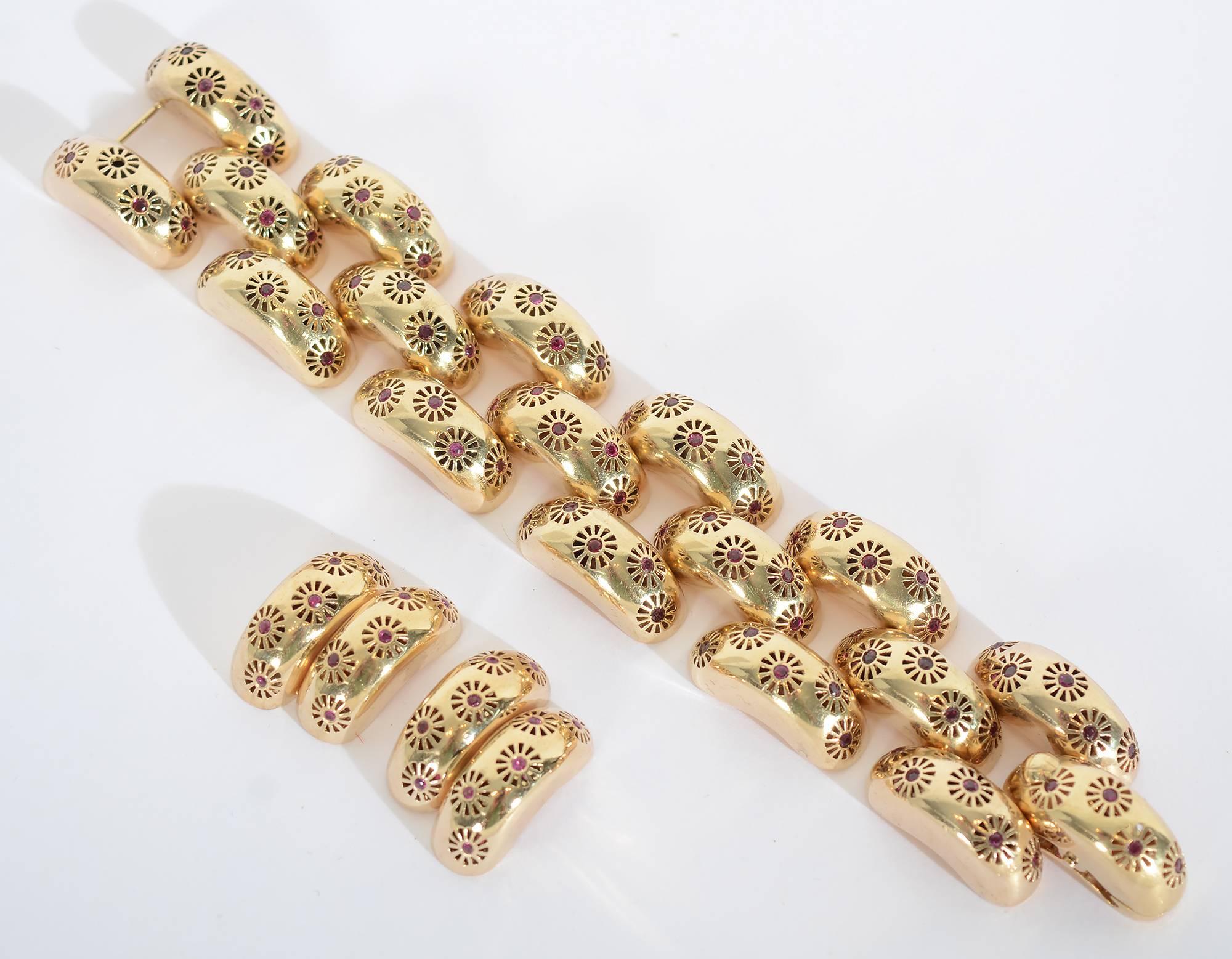 Dieses Retro-Goldarmband ist sehr ungewöhnlich, denn es hat ein rundes Design, das vollständig mit Rubinen besetzt ist. Die Glieder sind typisch für die Retro-Ära, aber die Hinzufügung des Rubinmusters hebt sie weit aus dem Rahmen des Erwarteten.