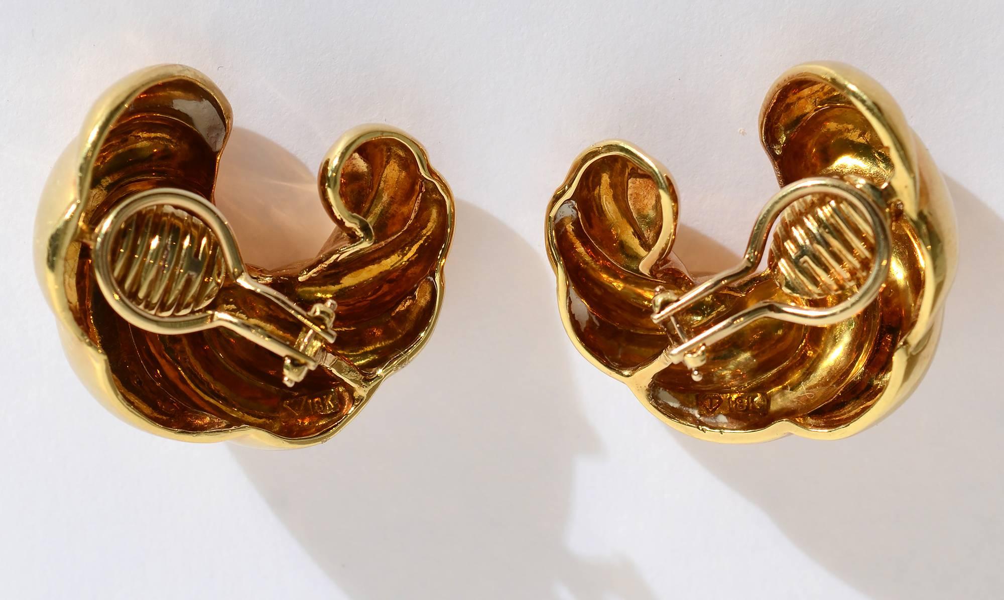 Eighteen karat gold, large crescent shaped earrings with an overall swirled design. The backs are clips that can be changed to posts. The earrings measure 1 1/4
