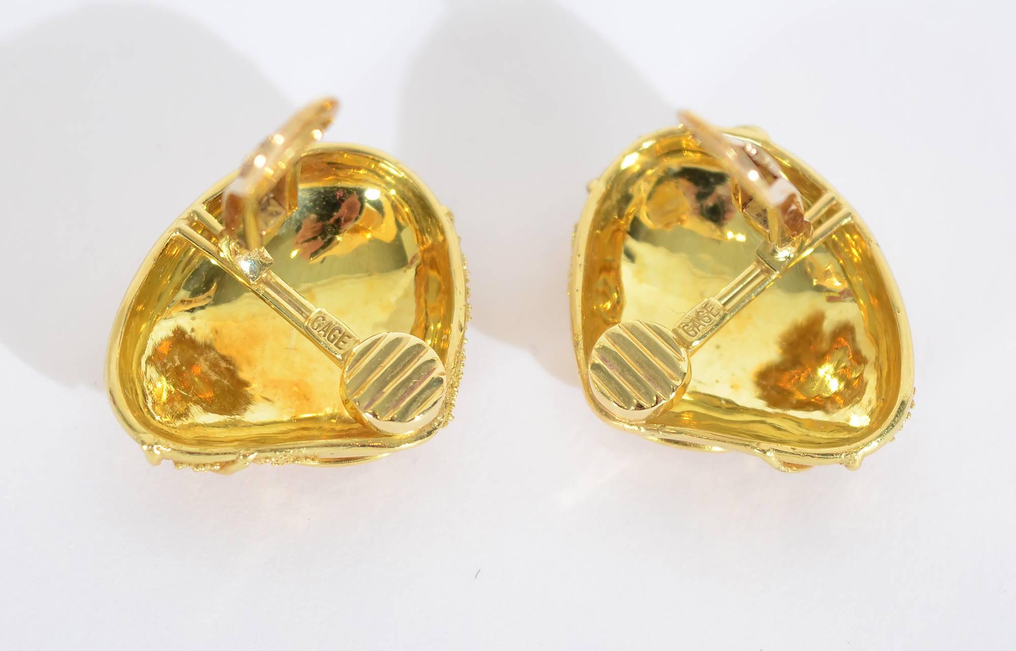 Bold 18 karat gold earrings by British jeweler, Elizabeth Gage in her granulation and wire  finish. Curvilinear designs in gold wire seem to anchor the minuscule gold beading. Backs are clips that can be converted to posts. Measurements are 1 inch