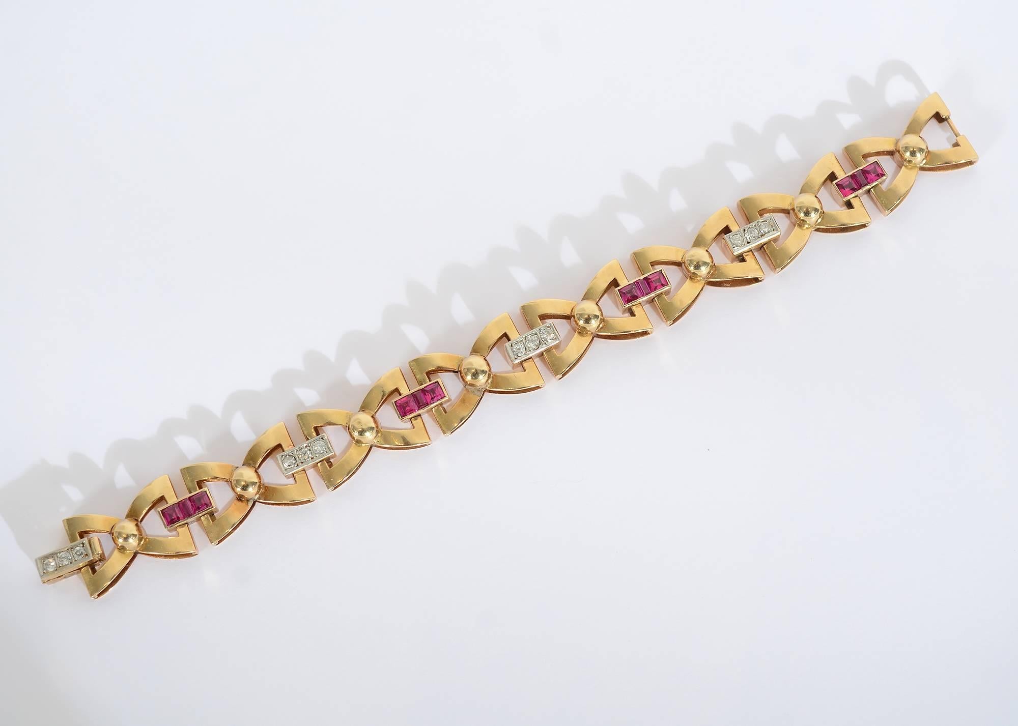 Graceful and unusual Retro bracelet enhanced with diamonds and rubies. Triangular links are joined to give the appearance of bows. Length is 7 5/16"; height is 5/8".