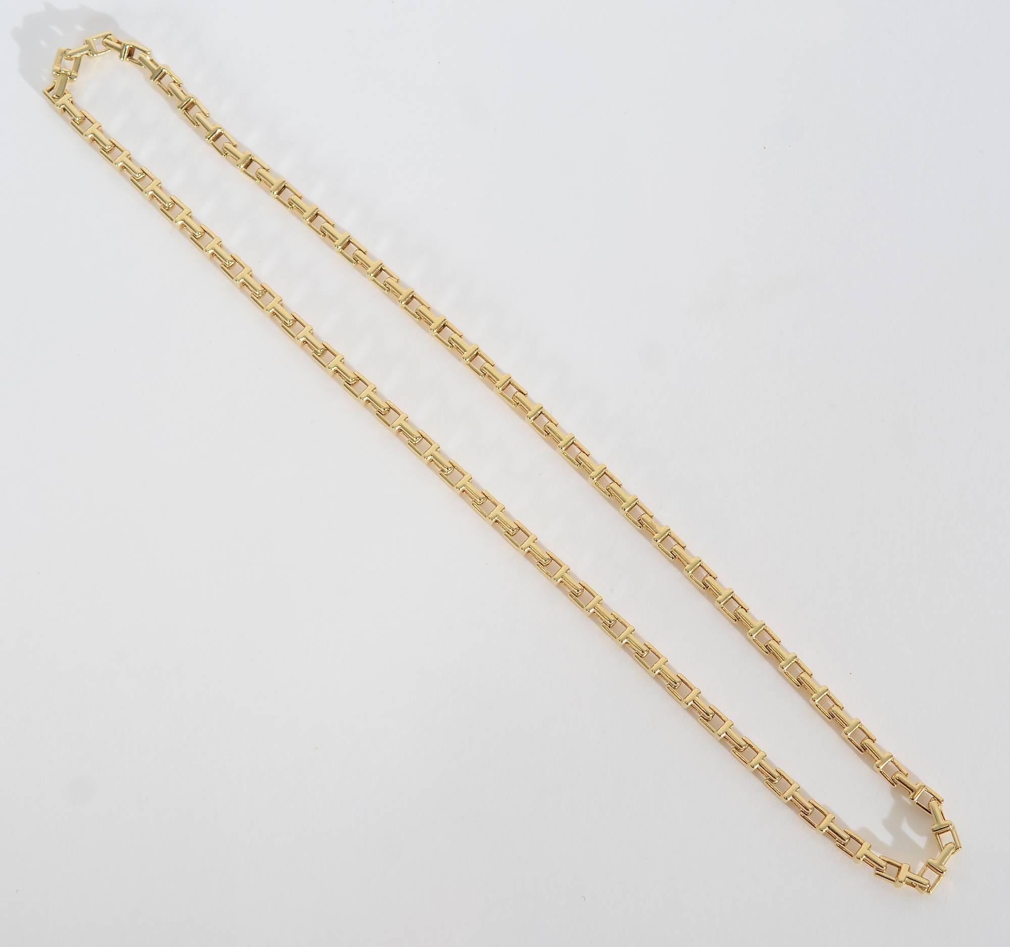 This square links 18 karat necklace by Tiffany easily stands on its own as a decorative necklace. In addition, it would work equally well a chain from which to hang a pendant. It measures 20 inches in length and 3/16 of an inch in width.