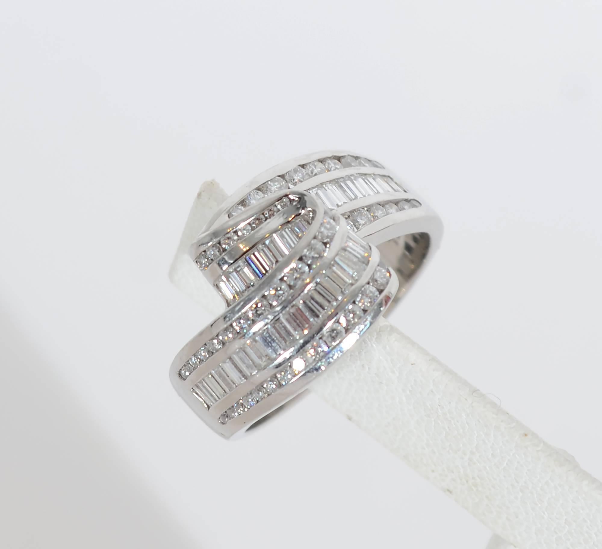 Stunning platinum and diamond ring by legendary American jewelry designer, Charles Krypell. The ring has the graceful appearance of undulating ribbon. It is made of 2.5 carats of VS quality round and rectangular diamonds. The ring is size 9 3/4. It