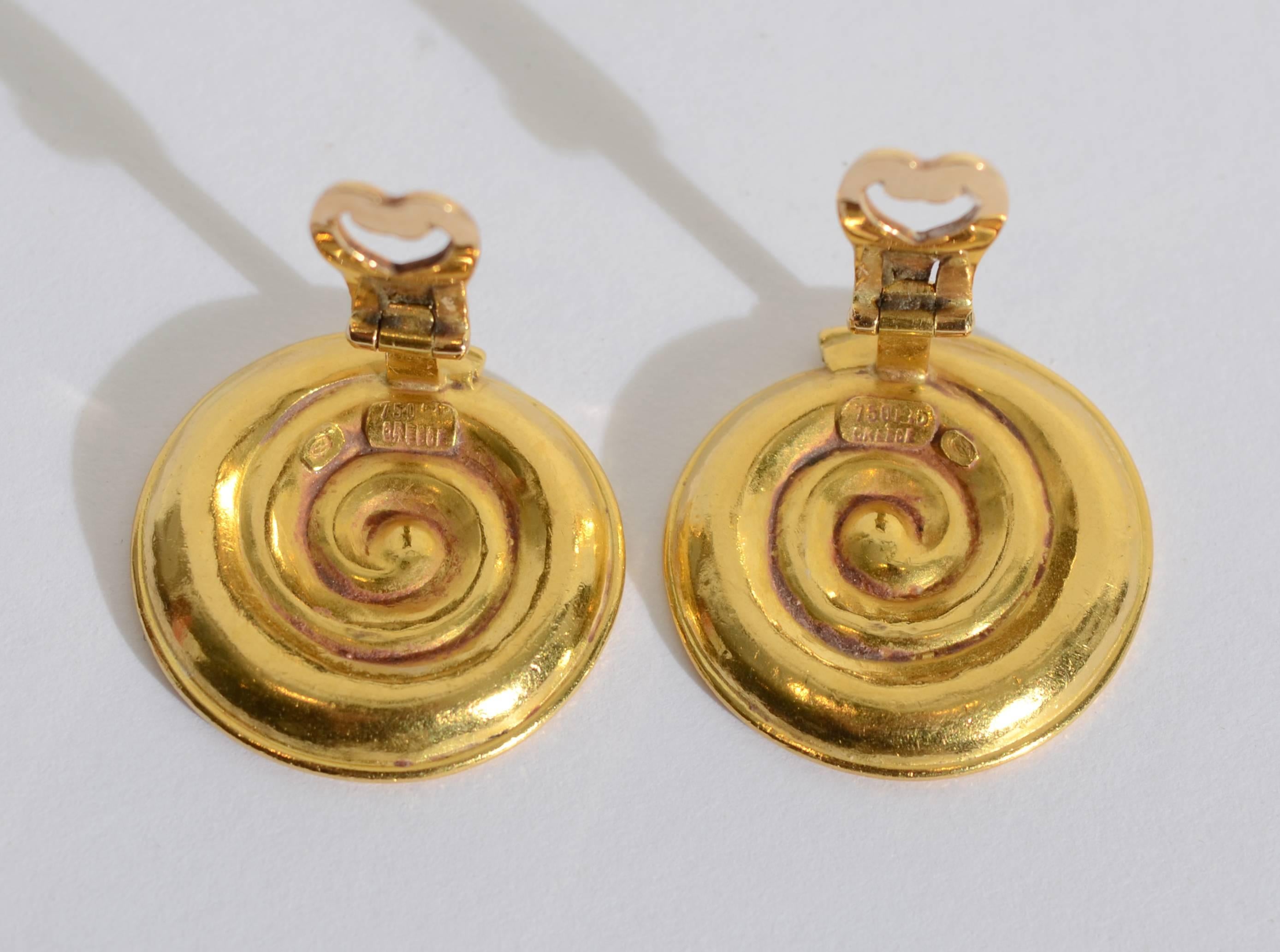Coiled disc ear clips by Greece's most admired jeweler, Ilias laLaounis. The bi-level coiled pattern is timeless in design  as much of laLaounis's work reflects his ancient heritage. They clips are 1 inch in diameter. Clips can easily be converted