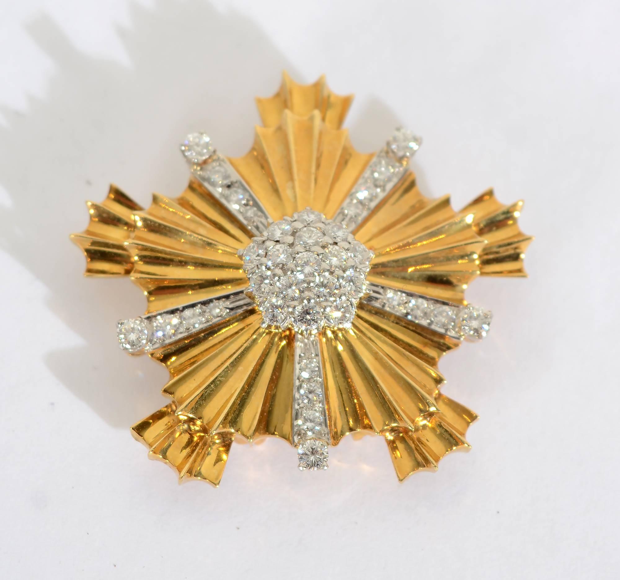 Tiffany 18 karat Retro brooch of a fluted five point starburst design. The central pave diamond cluster is dome shaped. Total diamond weight is approximately 1. 65 carats. Diamonds are set in platinum. They are vs quality, g color. The backing has