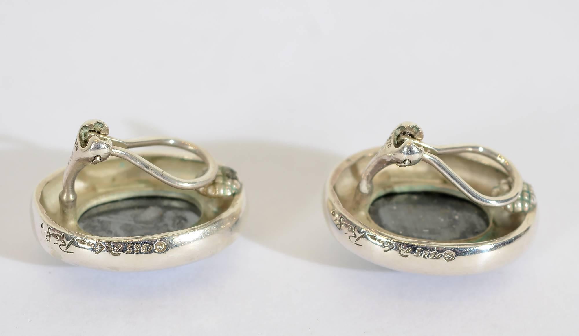 Bold and striking silver earrings with hematite by Pablo Picasso's youngest daughter, Paloma. They are signed Paloma Picasso and dated 1985. The earrings measure 1 inch in length and 3/4 inch in width. Clip backs can be converted to posts; excellent