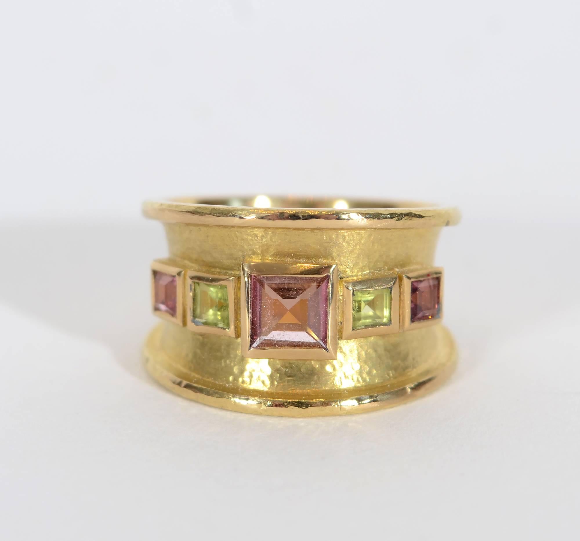 Elizabeth Locke wide band ring with alternating tourmaline and peridot. The band is 1/2" at the front tapering to 1/4" in the back making it both graceful and very comfortable to wear. The central stone is 3/8" square. The surface of