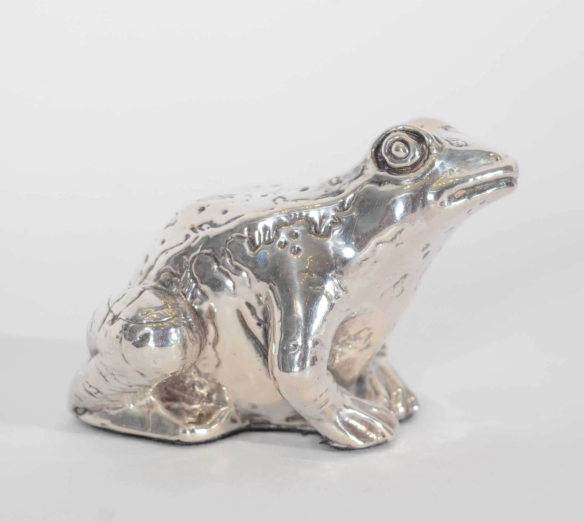 This charming  tabletop toad would amuse any frog collector. It is nicely textured  and  has a happy look. The frog measures 1 15/16