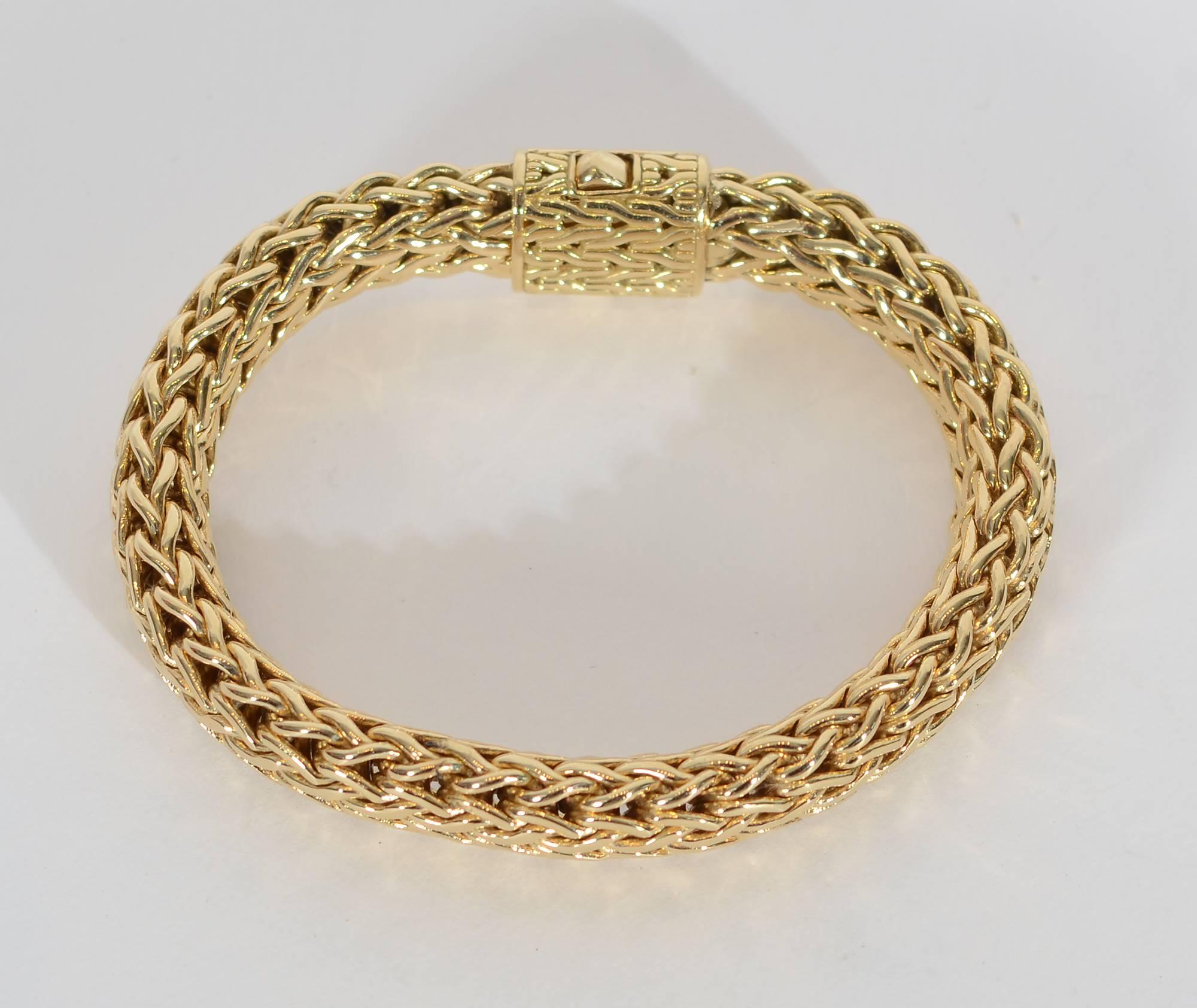 This 18 karat gold bracelet has an wonderfully complex weave.  It weighs a substantial 96 grams.
The clasp is well integrated into the design so it can be work on top of the wrist as an ornamental form or in the back in the more traditional way. It