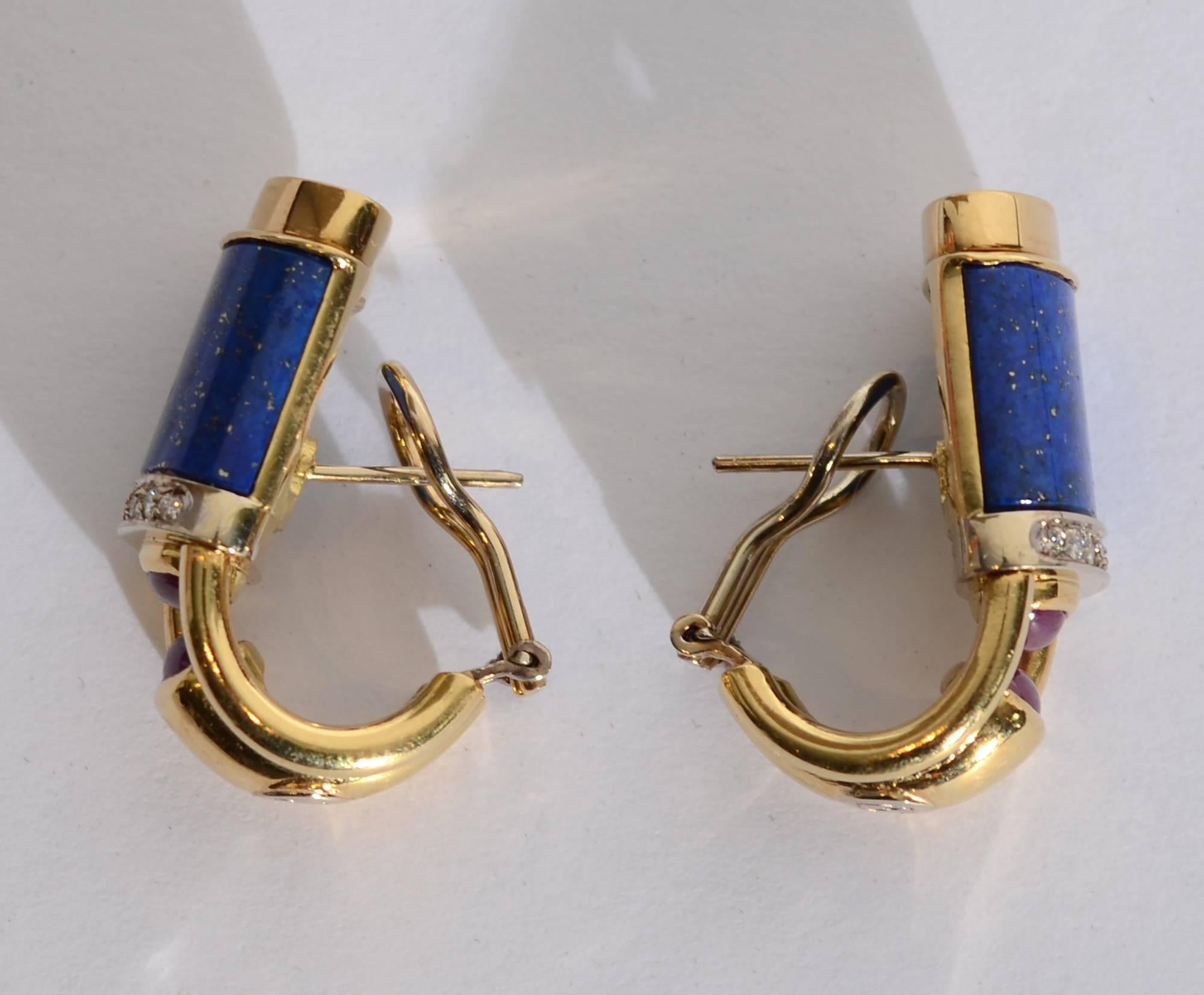 Striking earrings that are both colorful and architectural. Beautifully colored stones of lapis lazuli have 7 diamonds on the bottom of each. Below them is an imaginative placement of two cabochon rubies facing each other from the top and