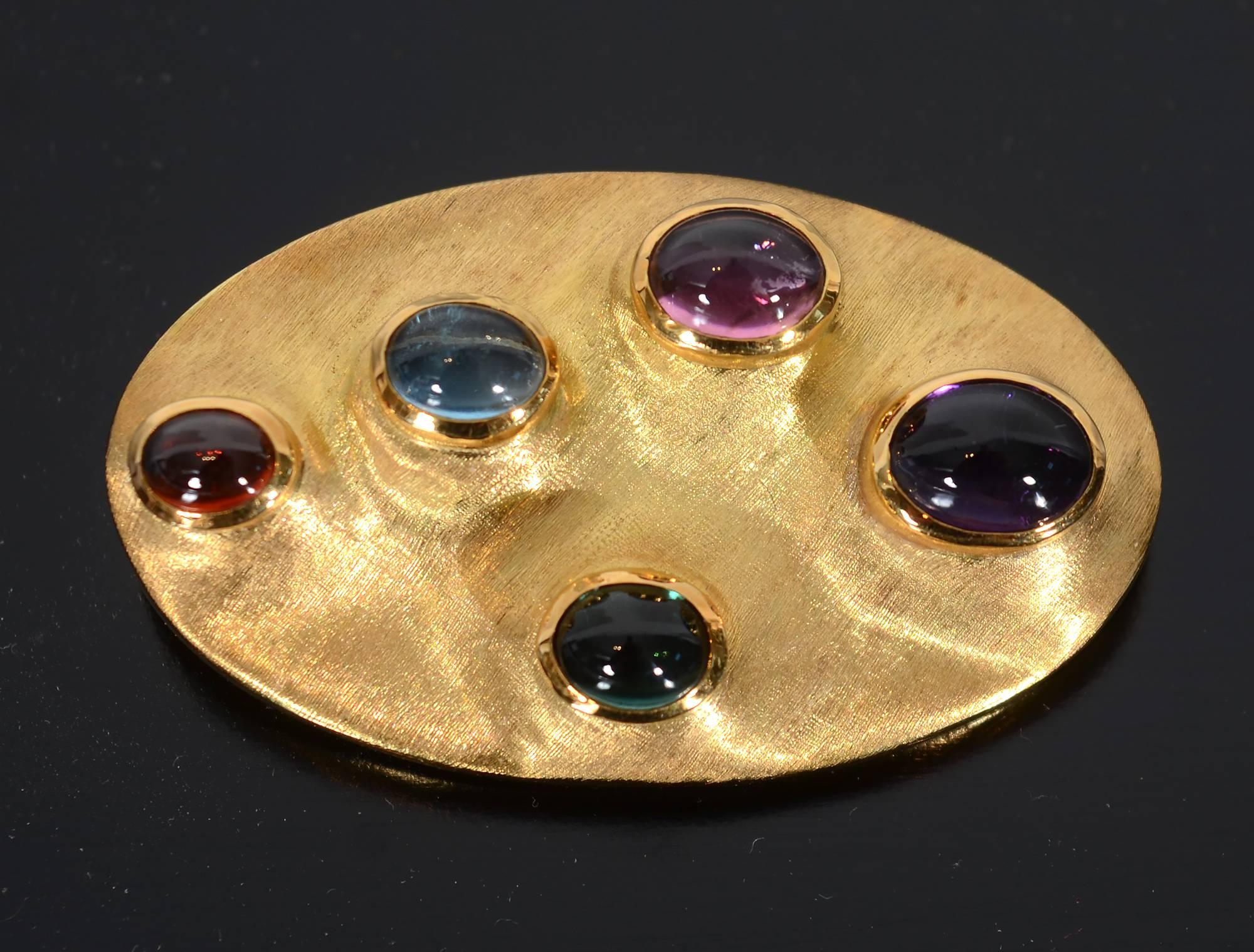 Unusual brooch by Brazilian jewelers Roberto and Haroldo Burle Marx. In addition to having a soft burnished finish, the brooch is enhanced by an undulating surface. Irregularities are quite intentional - not flaws. The oval cabochon stones are