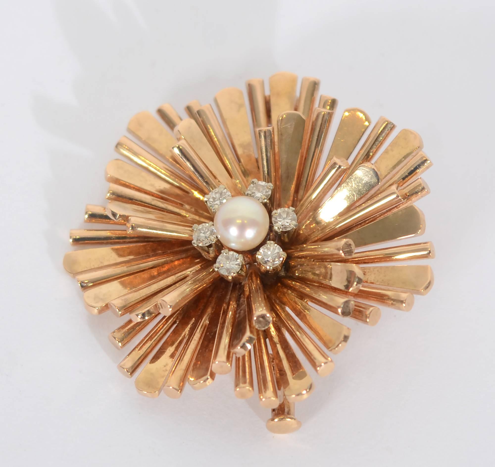 Different size spokes are fanned on several levels to make  this  Retro brooch especially graceful.  It is centered with a 5.8 mm cultured pearl that is  surrounded with 6 diamonds.
It measures 1 1/4 inches in diameter and length.