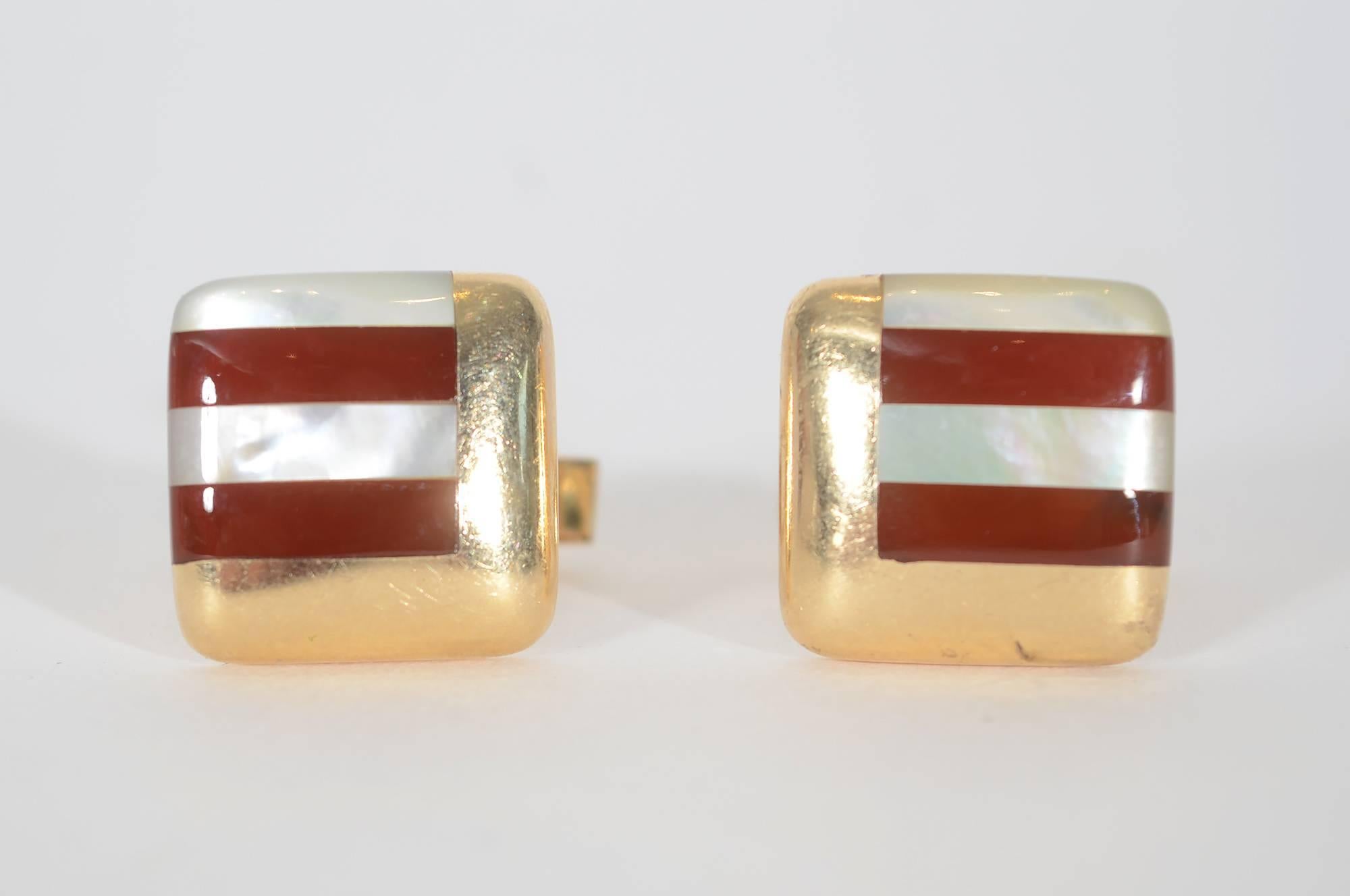 Carnelian and mother of pearl cufflinks by Asch Grossbardt. Two sides of the stones are surrounded by a right angle of gold making an interesting geometric pattern. 