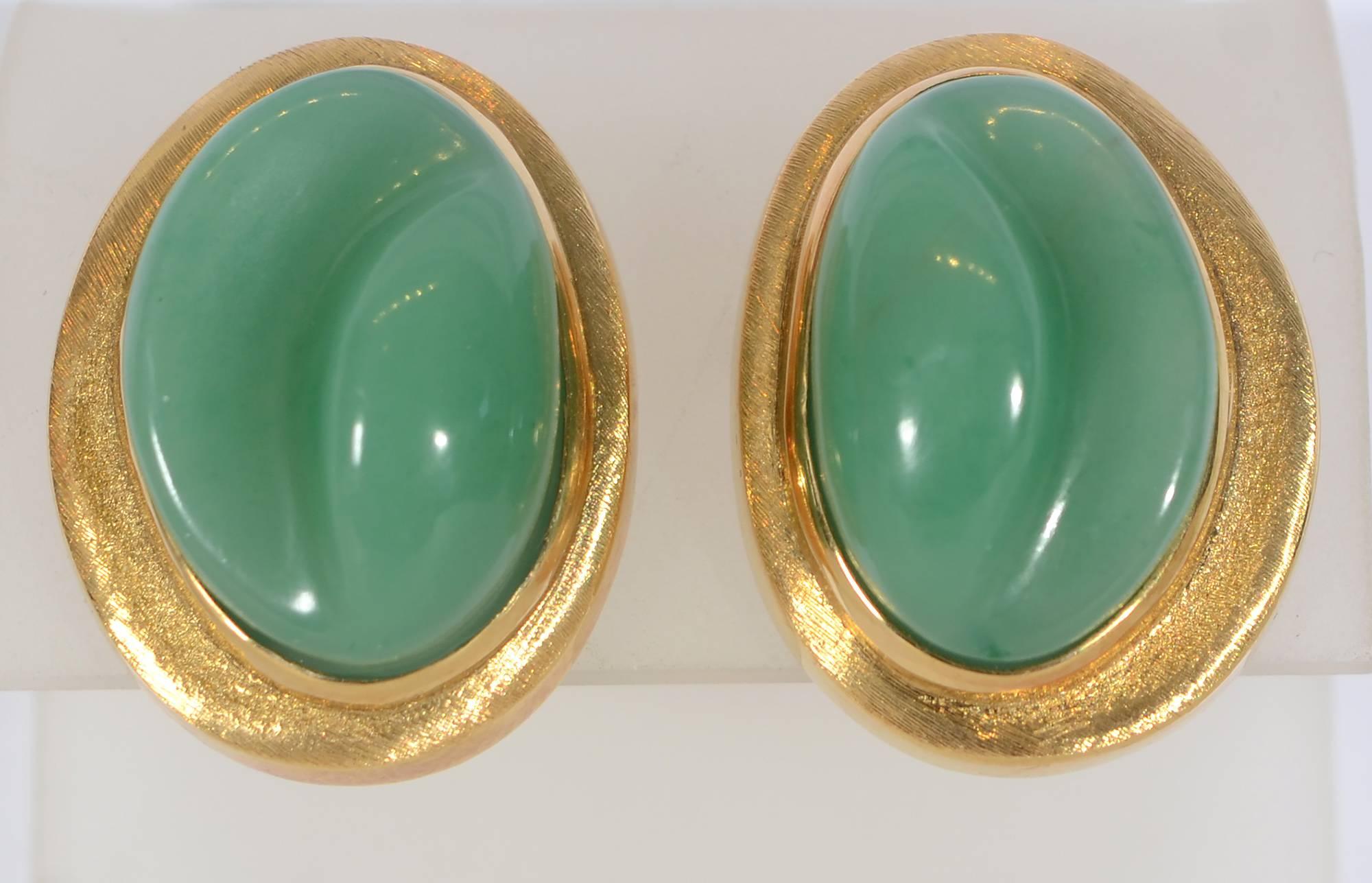 Beautifully carved chrysoprase oval gold earrings by Burle Marx. The irregular platform on which the stones sit have the lightly brushed finish often used by Burle Marx. The sides, however, of the bezel and the platform have a gloss finish.  Clip
