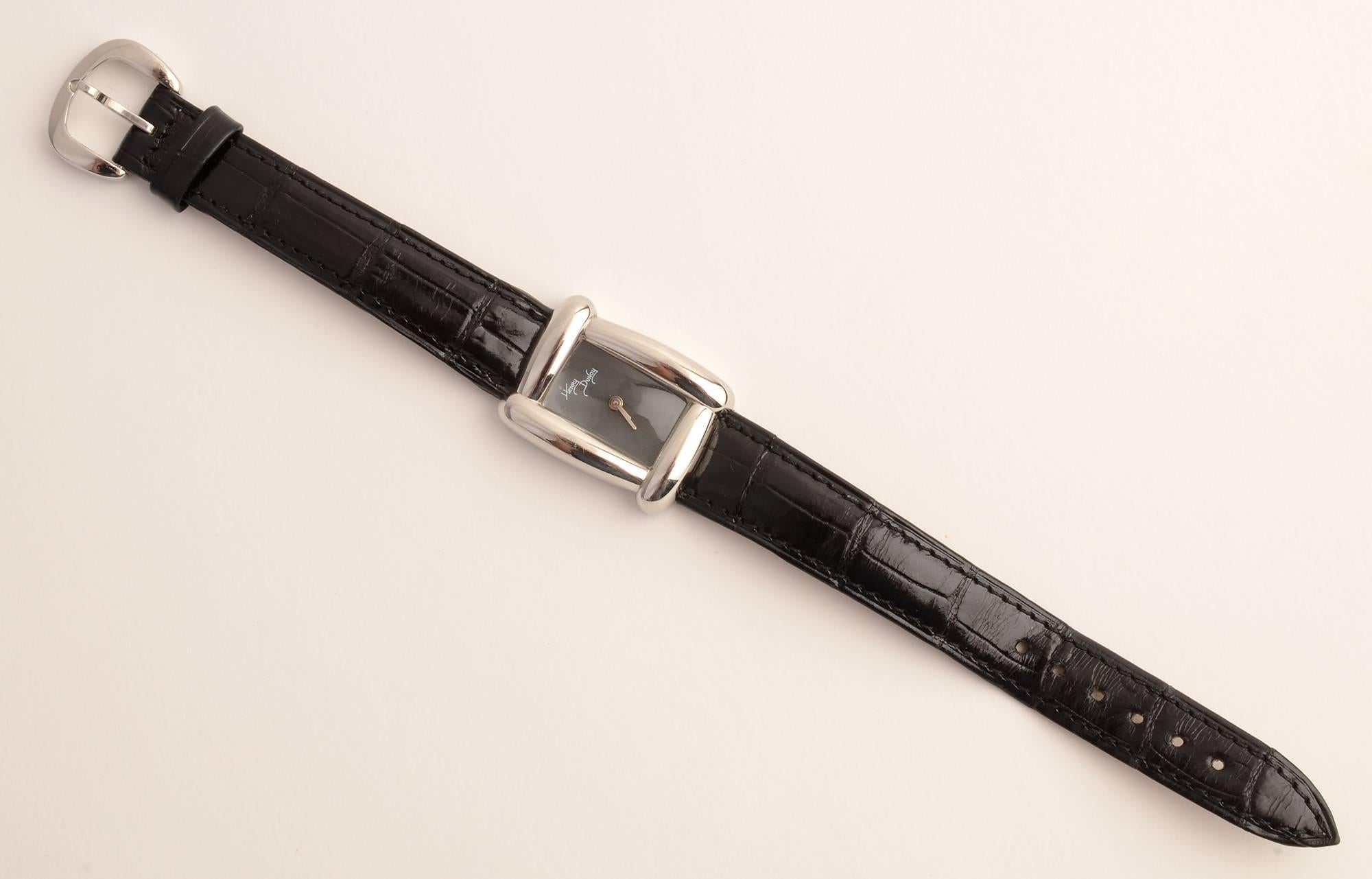 Stylish wrist watch by American jewelry designer, Henry Dunay. The rectangular black face is framed by the curvilinear design characteristic of his watches. Black leather band is original. 
