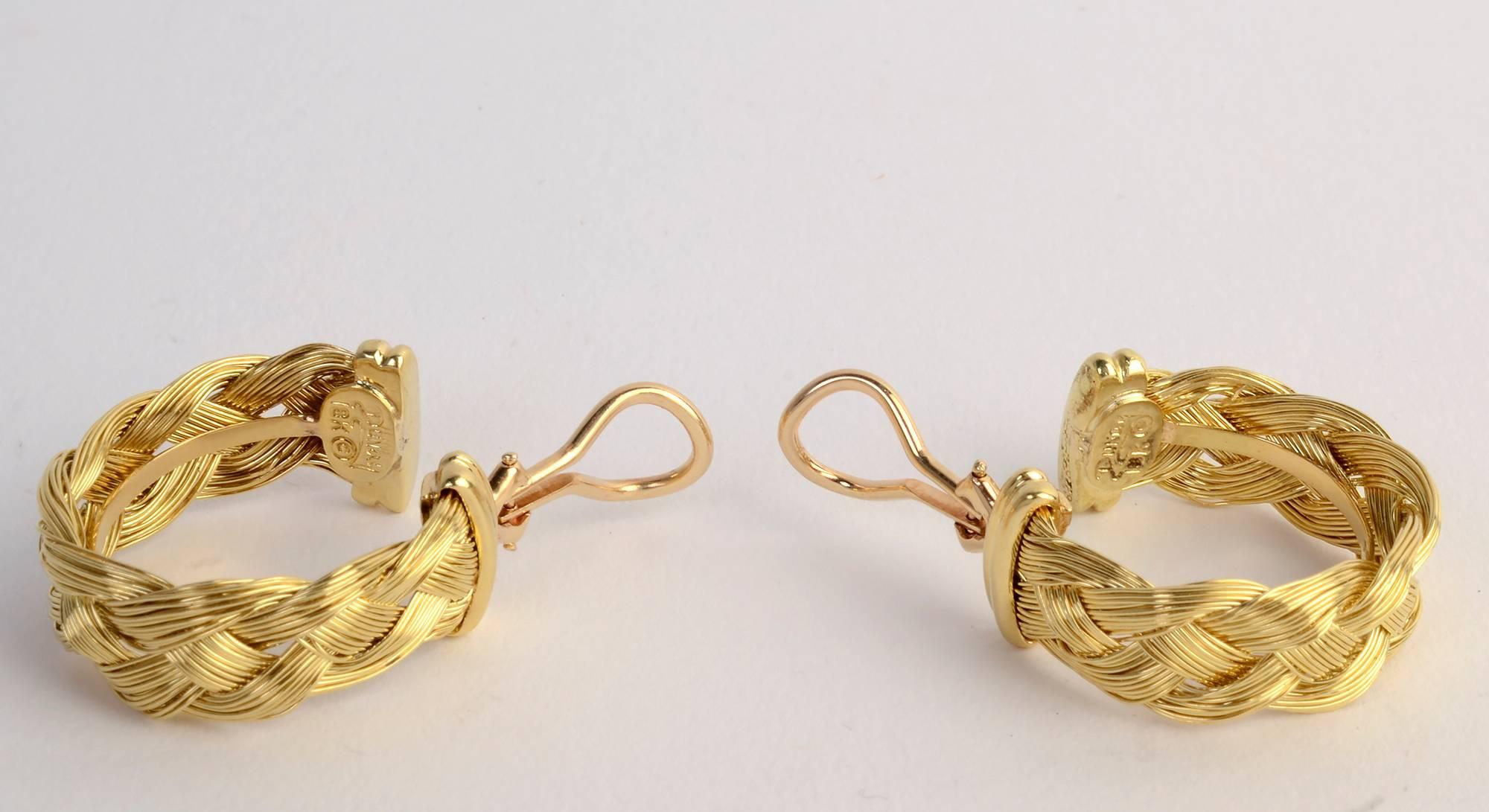 Multiple strands of eighteen karat gold are braided into hoop earrings by Henry Dunay. Backs are clips.The earrings are 7/8 