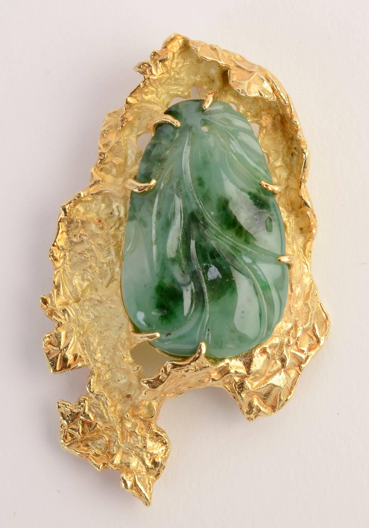 Freeform gold surrounds a carved jade stone in this pendant and brooch by iconic Modernist  jeweler, Ed Wiener. The piece is particularly versatile in that the pinstem allows for it to be worn horizontally while the pendant loop hangs it vertically.