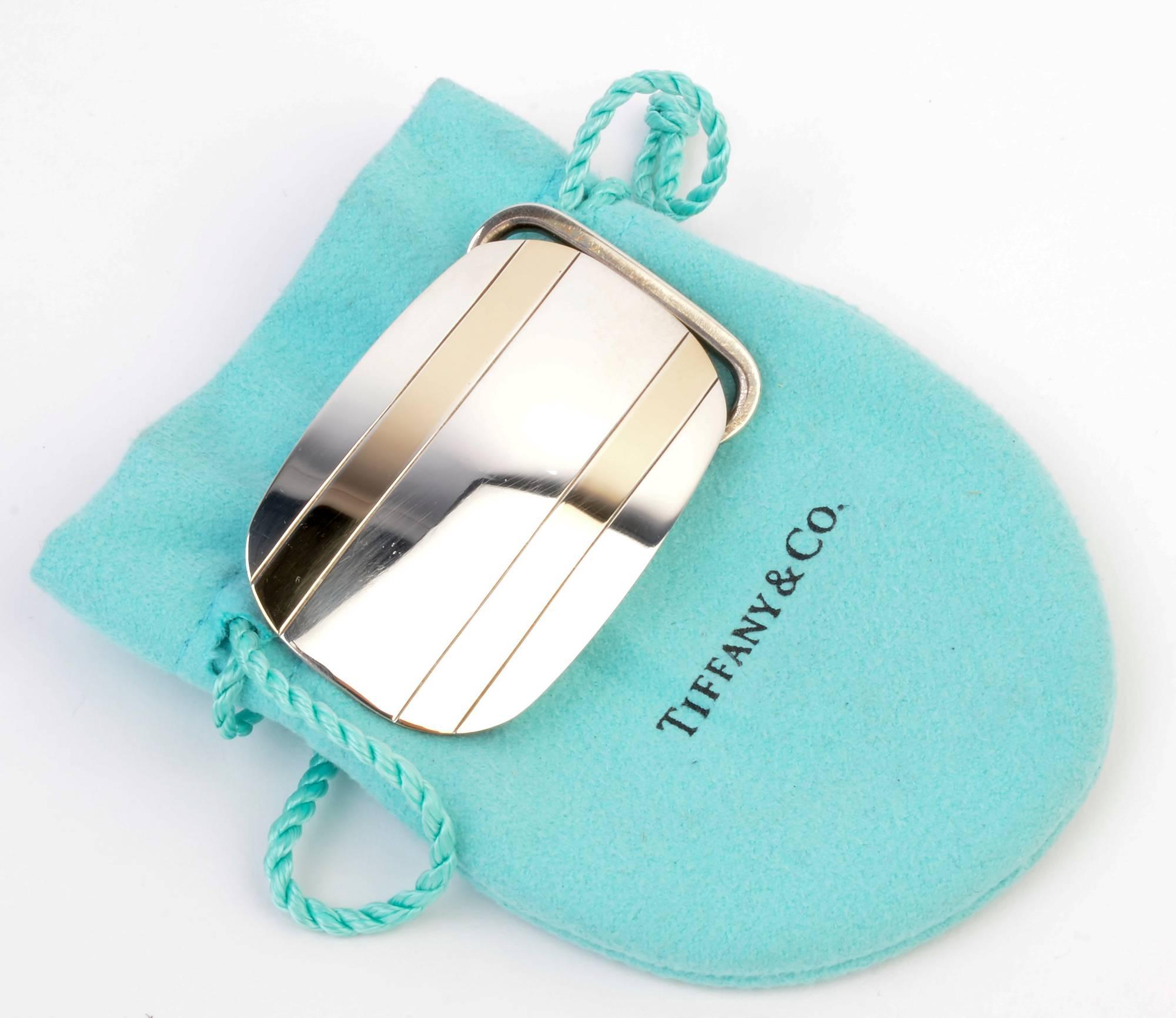 Tiffany made Retro belt buckle of sterling silver and 14 karat gold. The buckle accommodates a belt 1 inch wide. The buckle is perfectly unisex. It has been professionally polished and is in excellent condition. It is 2 inches wide and 1 1/4 inches