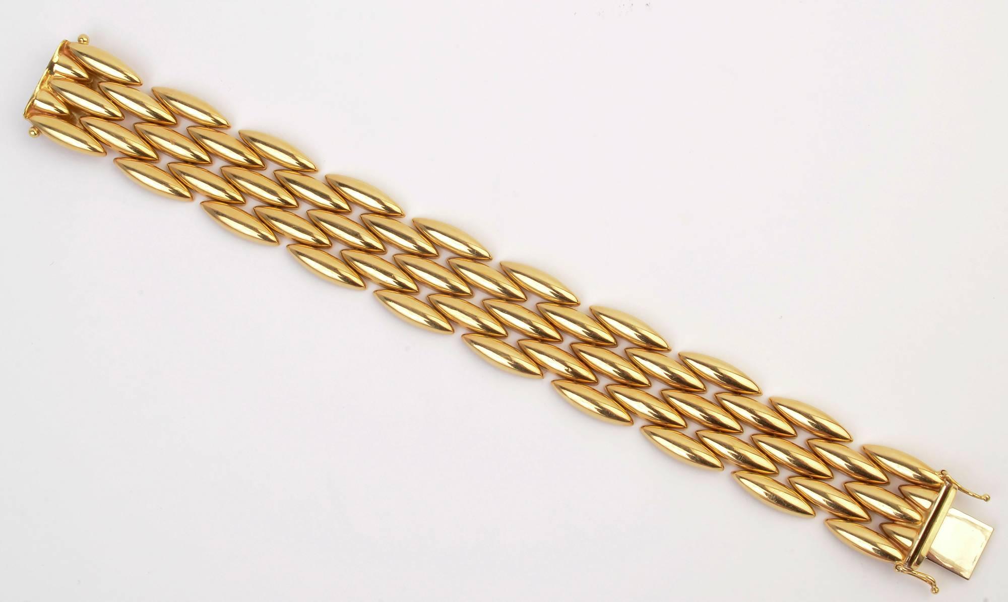 Classic eighteen karat gold bracelet by Cartier with five rows of navette shaped links. The matching necklace is offered as item LU1333250523. Both are an especially rich shade of gold. The bracelet is 3/4" wide and 7 5/16" long.