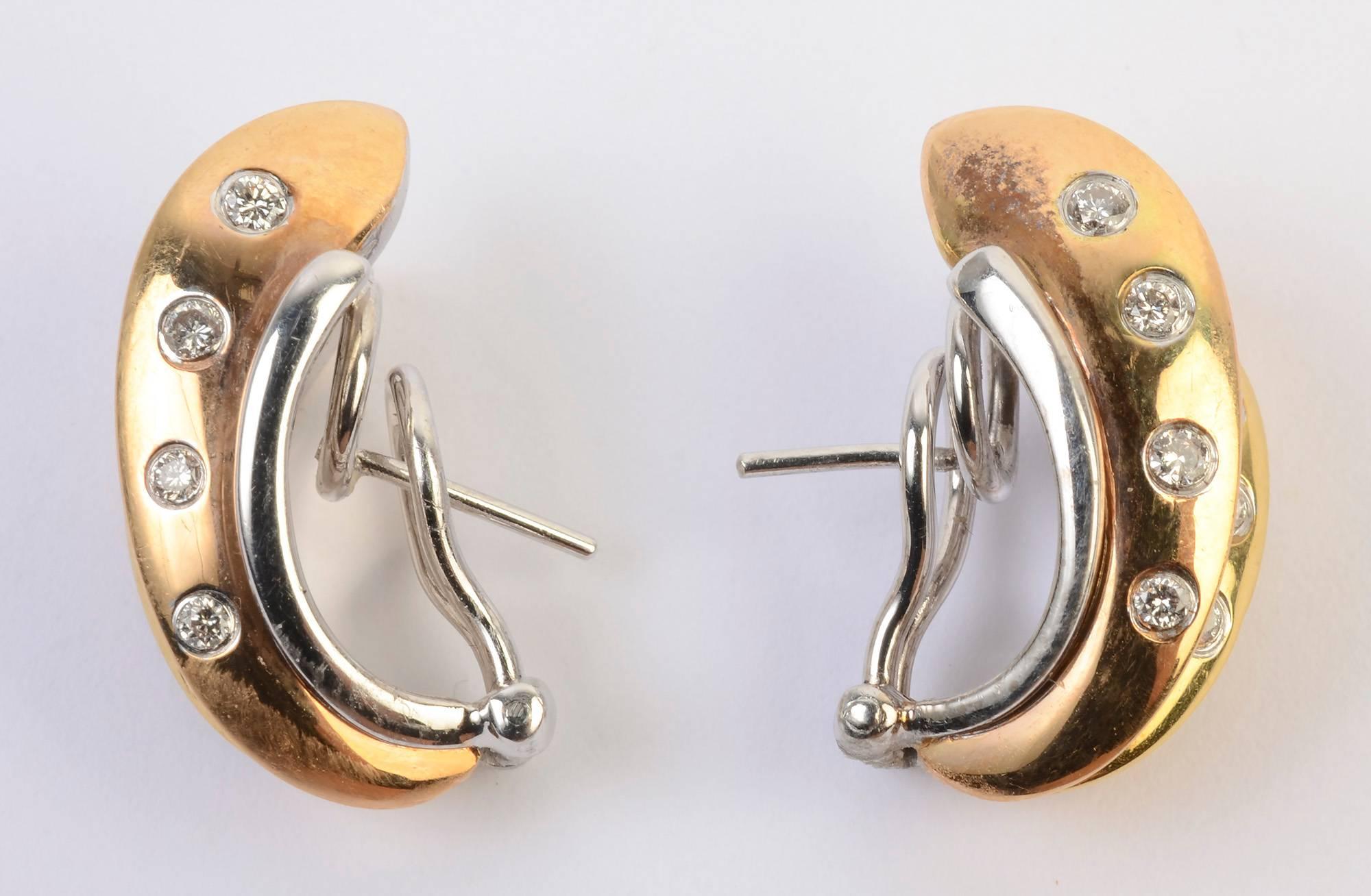 Irregular hoop earrings of yellow and white gold with diamonds. The hoop shapes are four different size and forms, alternating white and yellow color. Backs are posts and clips.  Measurements are 7/8" x 1/2". 
