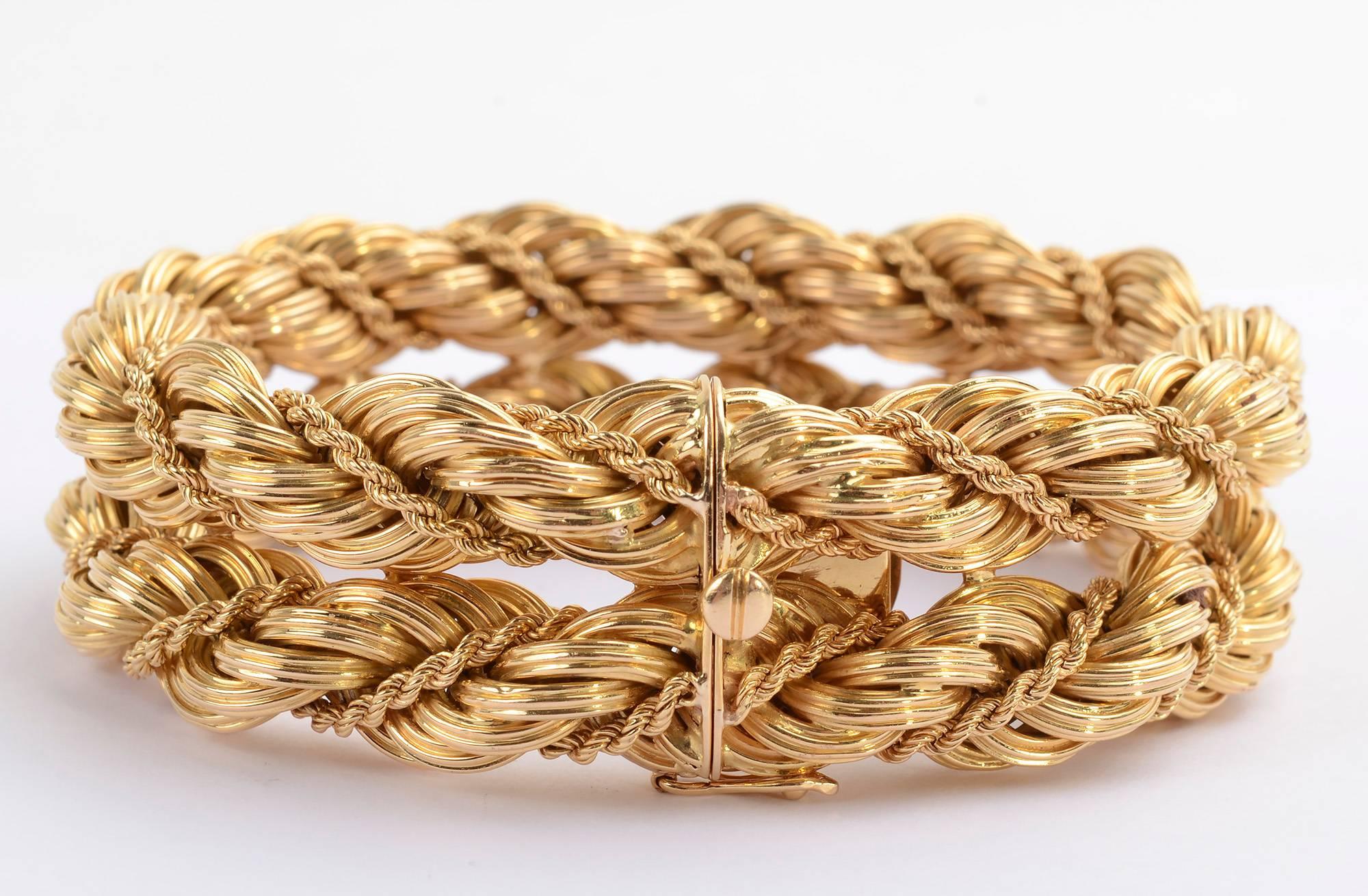 Chunky Tiffany 18 karat gold bracelet consisting of two connected rows of twisted gold. Each row has a thick twist around which is a much thinner strand of twisted gold. The bracelet measures 8 1/8 inches in length which may be misleading. Because