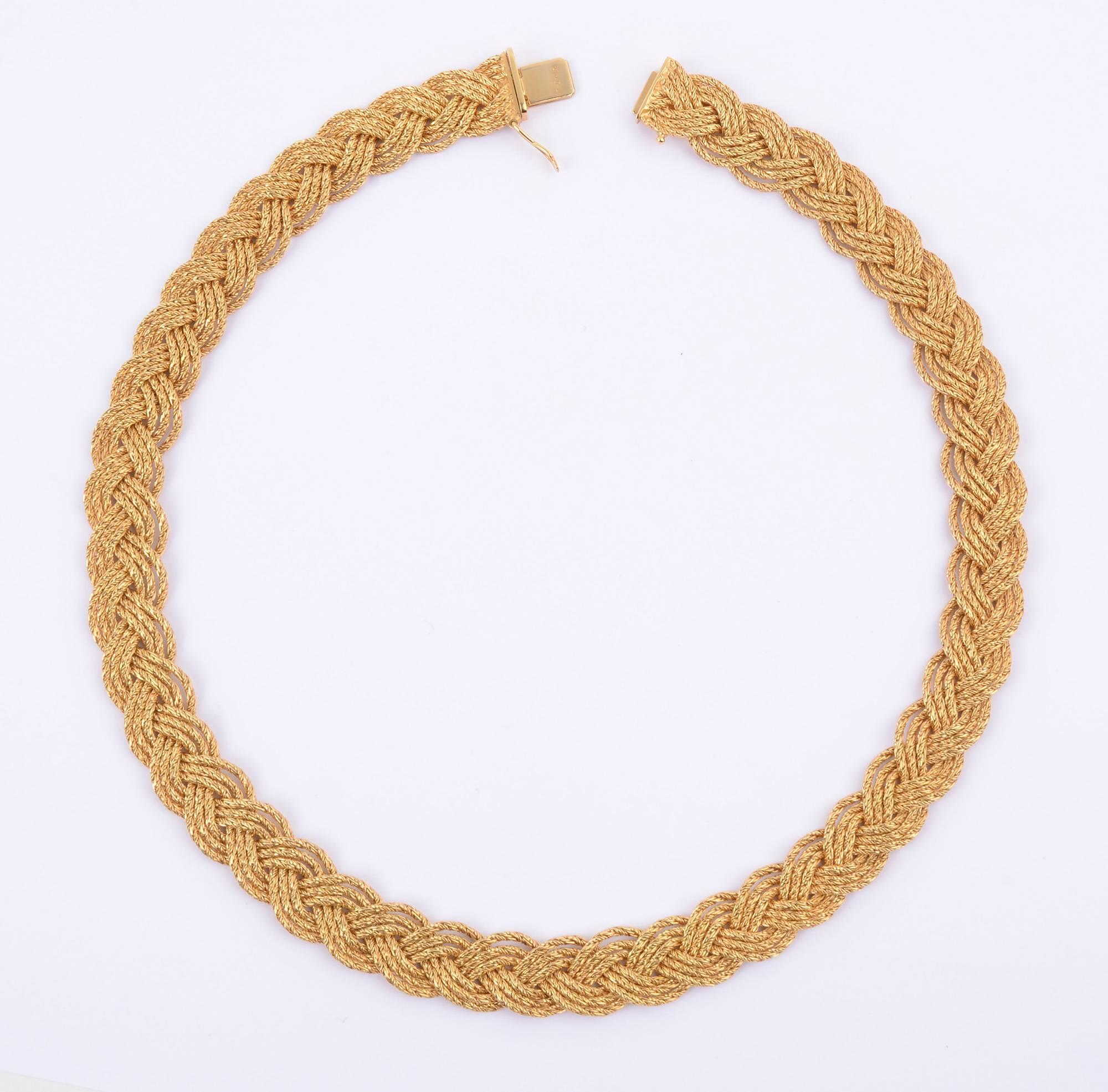 Beautiful eighteen karat gold choker necklace by Tiffany and Co. It is made of three braided strands of gold. Each strand is made  with a herringbone weave. The complexity of the braiding with the herringbone gives a wonderful glimmer to the