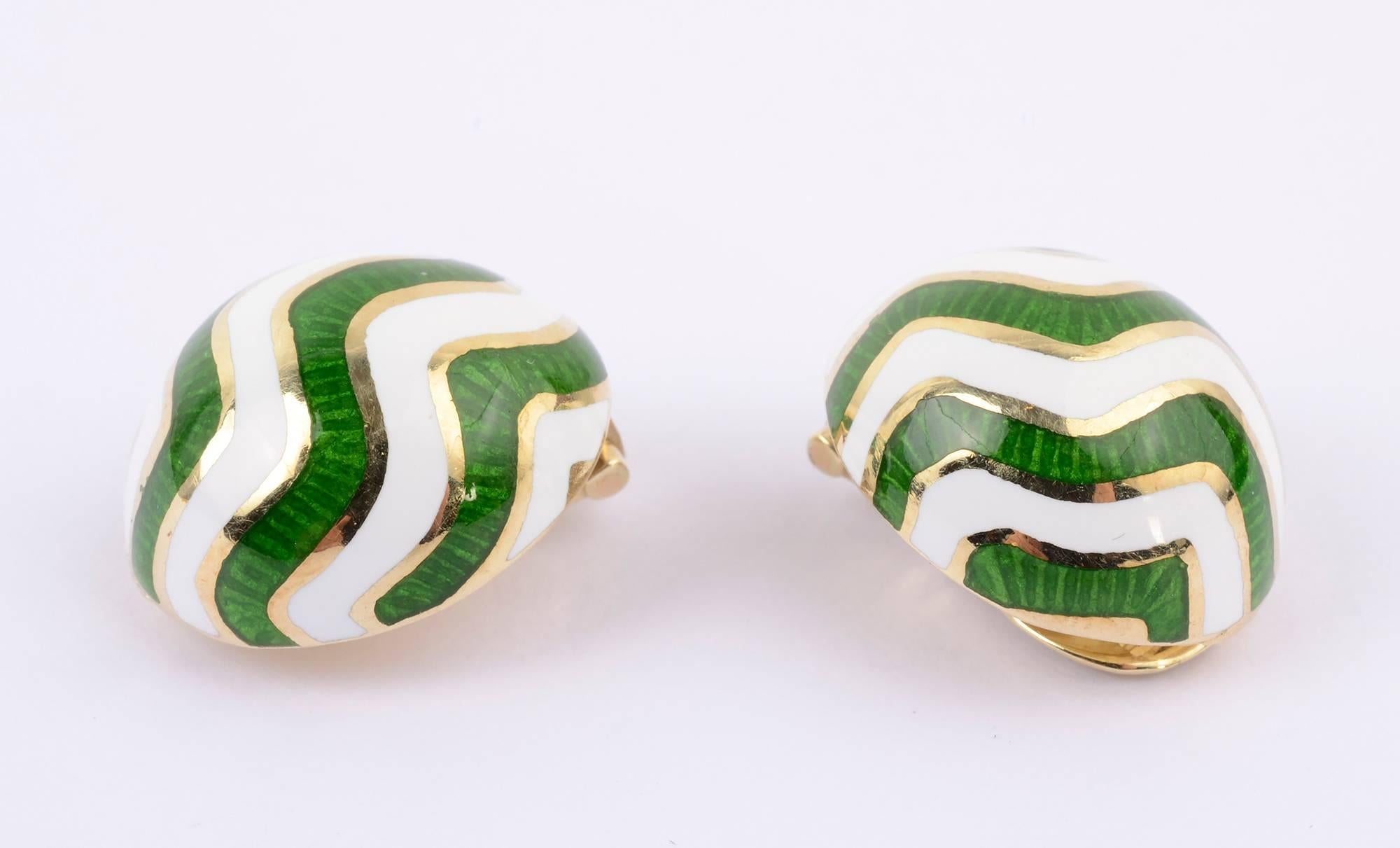 Jazzy enamel earrings by Martine. The alternating zigzags of green and white enamel are banded with 14 karat gold. Backs are clips. The oval earrings measure 3/4 inch x 7/8 inch. Light spots are reflections - they are not damage.