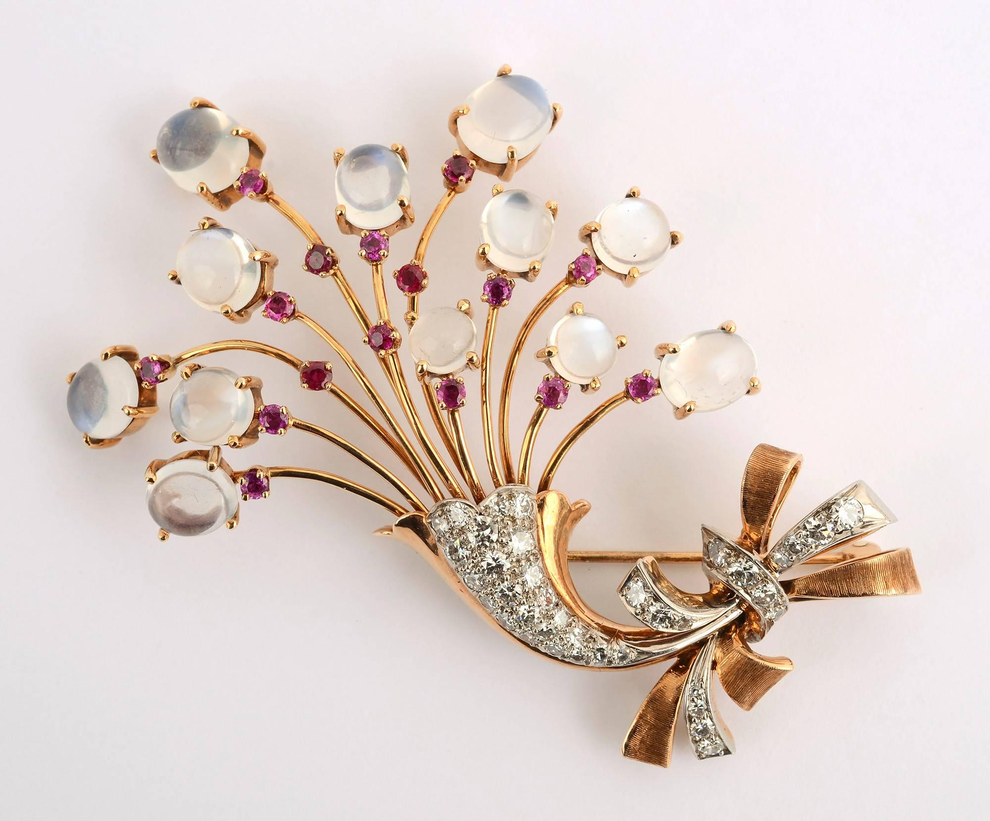 What could be more Retro than this floral brooch with matching earrings made of 14 karat gold with moonstones, diamonds and rubies? The bouquet is tied at the bottom with a graceful bow that is repeated in the earrings. Backs are clips of white