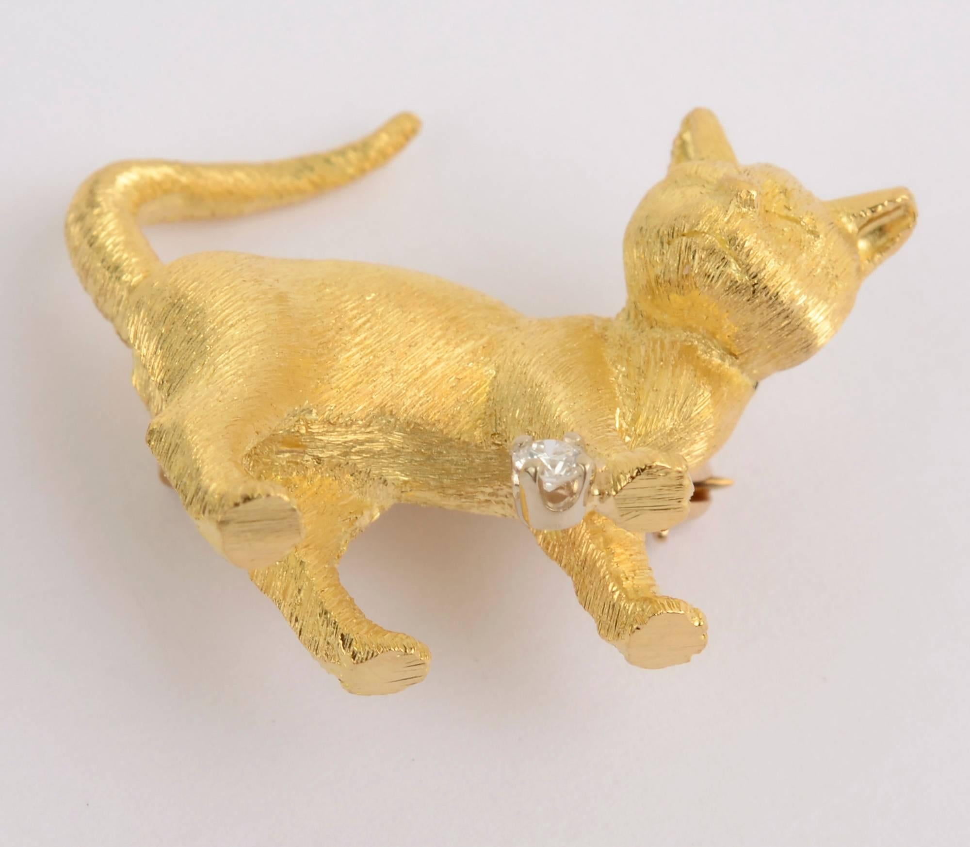 Charming brooch of an 18 karat gold cat with very fine detail. The feline is beside its diamond ball. The brooch stands flat so while not being worn, it can be enjoyed as the small beautiful sculpture it is. Made by Craig Drake, Philadelphia's late