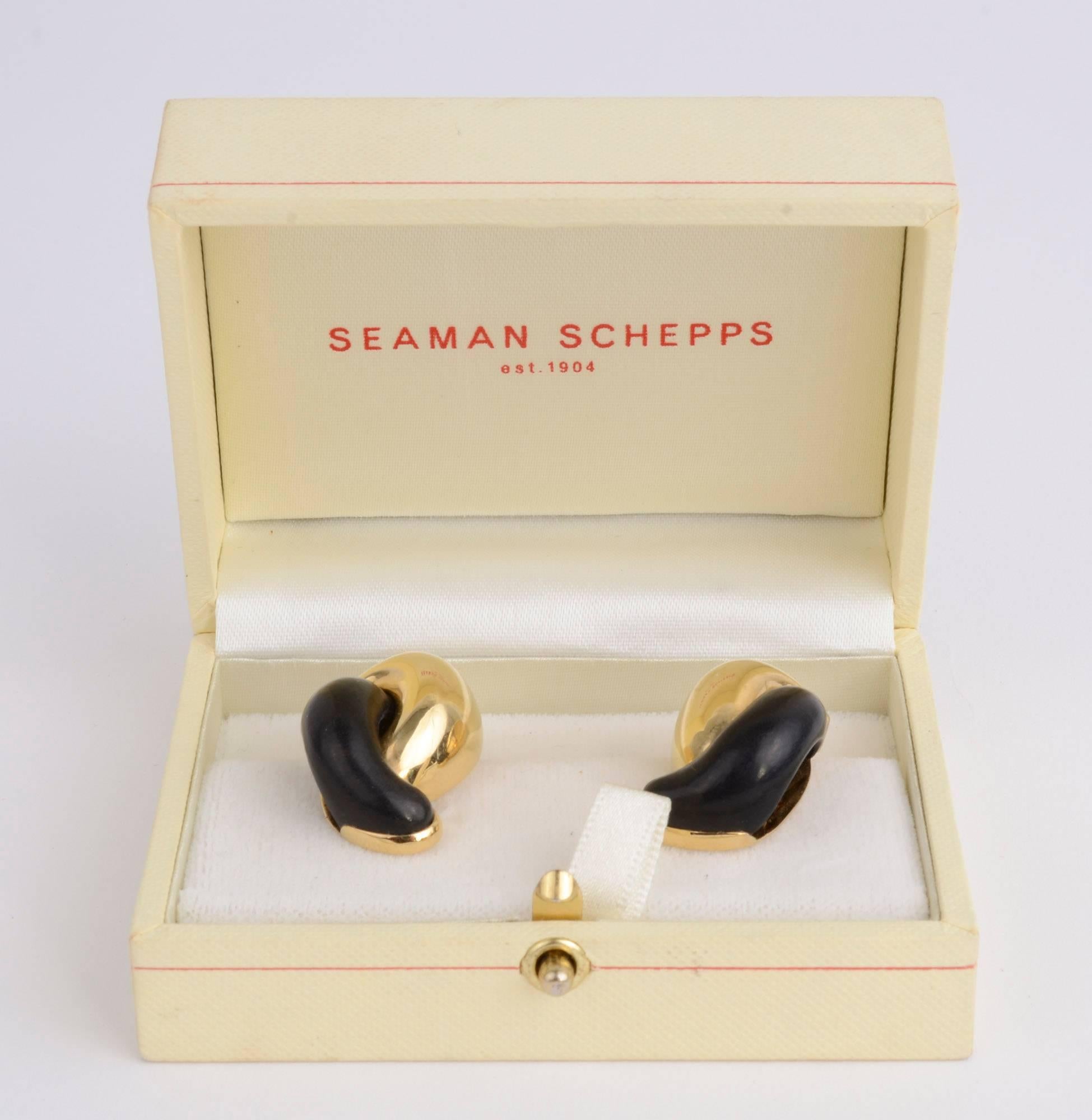 Seaman Schepps gold half circles interlock with half circles of dark wood in these wonderful, sporty earrings. They measure 1 1/8 inches in length and 5/8 inch in width. Clip backs can be converted to posts. Sold with the original Seaman Schepps