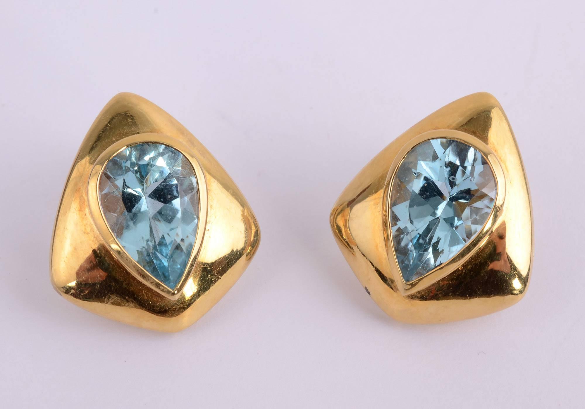 Modernist 18 karat with blue topaz earrings by H. Stern. The pear shaped stones are  the reverse of the gold in which they are set making for an interesting design. The earrings are 15/16 