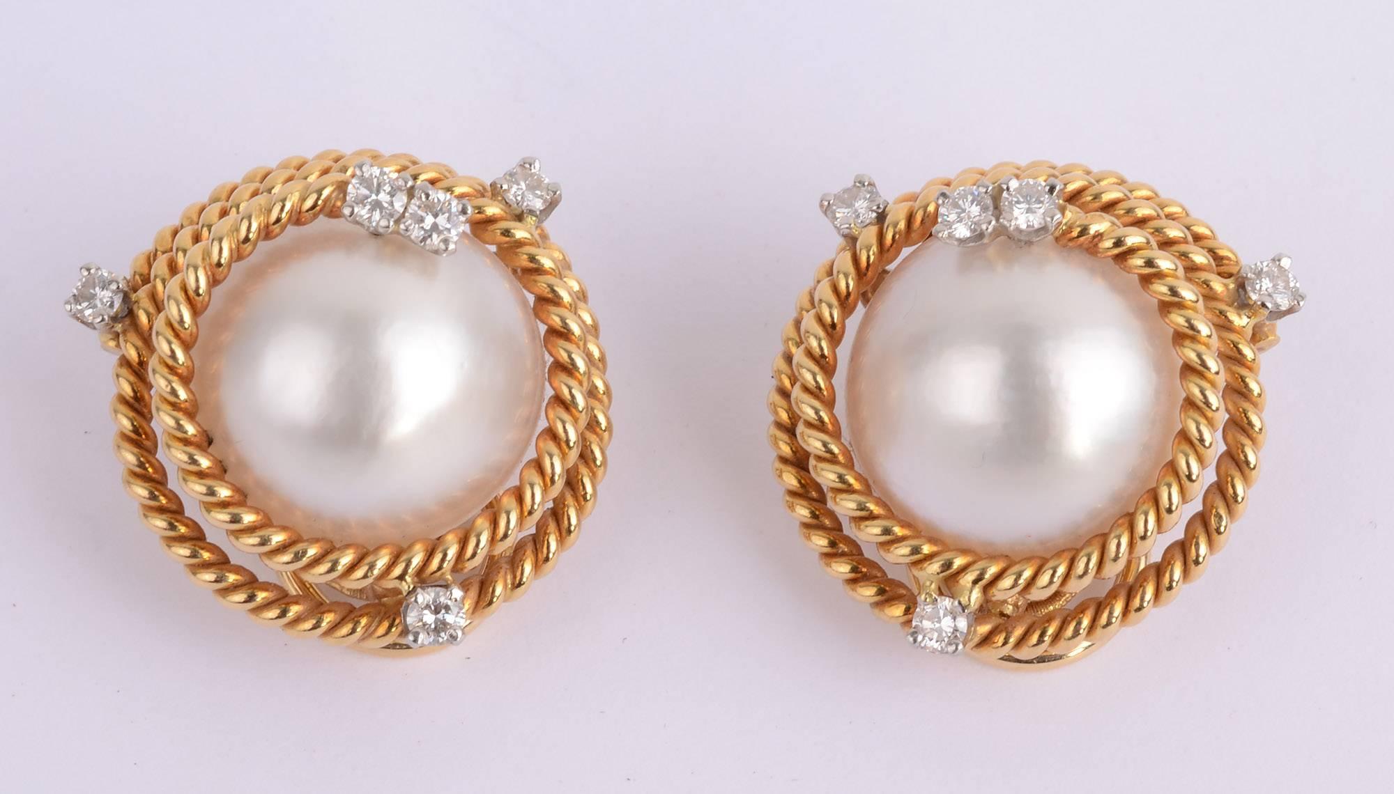 Pair of gold and mabé pearl and diamond earclips by Jean Schlumberger for  Tiffany & Co.
Two mabé pearls, approximately 15.0 mm., are wrapped in rope-twist 18 karat gold, accented by 10 round diamonds approximately .50 ct.
 With signed pouch and