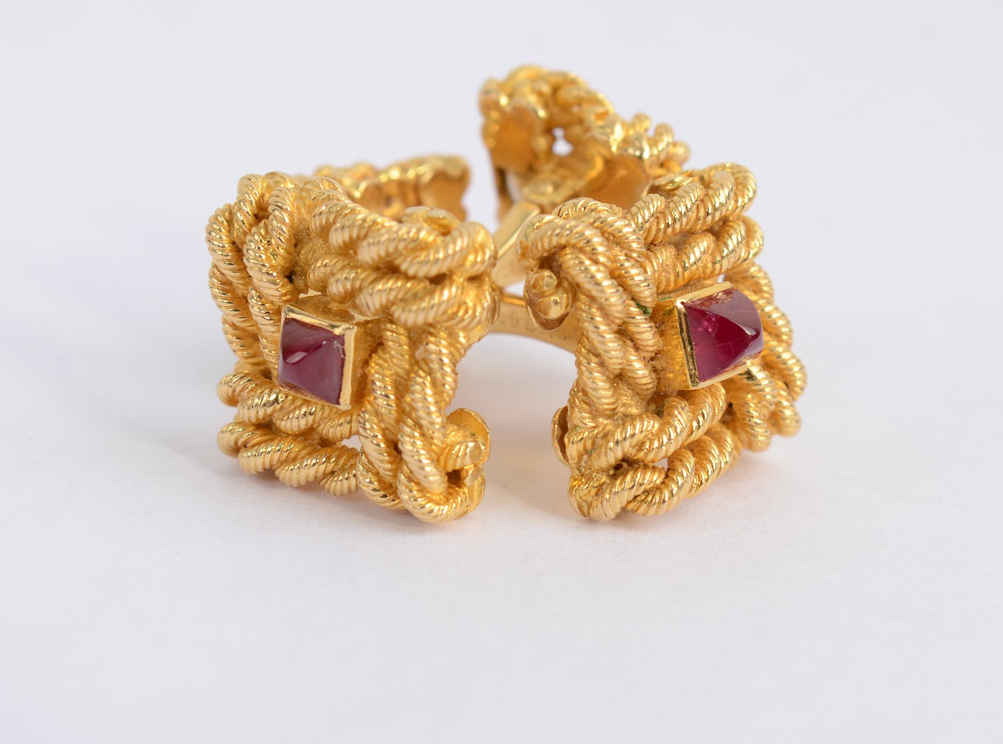 It is difficult to imagine cufflinks more elegant than this pair by Van Cleef and Arpels France.  Both ends are twisted gold roping centered with a ruby. The backs are hinged.
They measure 1 inch in length. The larger square is 5/8