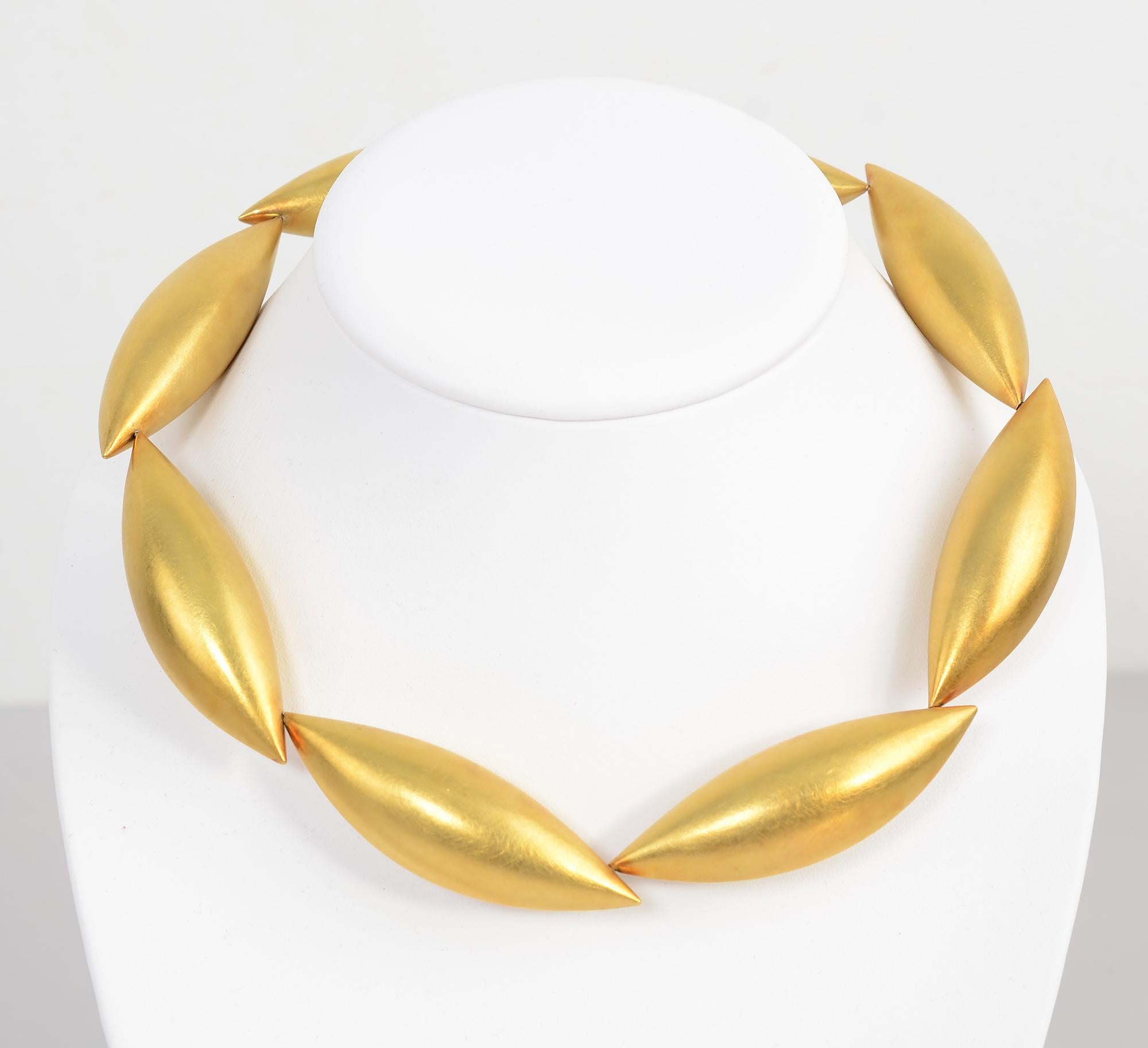 German artist Erich Zimmerman has named this stunning gold choker necklace his Cocoon design. It consists of 8 slightly overlapping elongated tubes with a soft matte finish.  Each tube is 2 9/16 