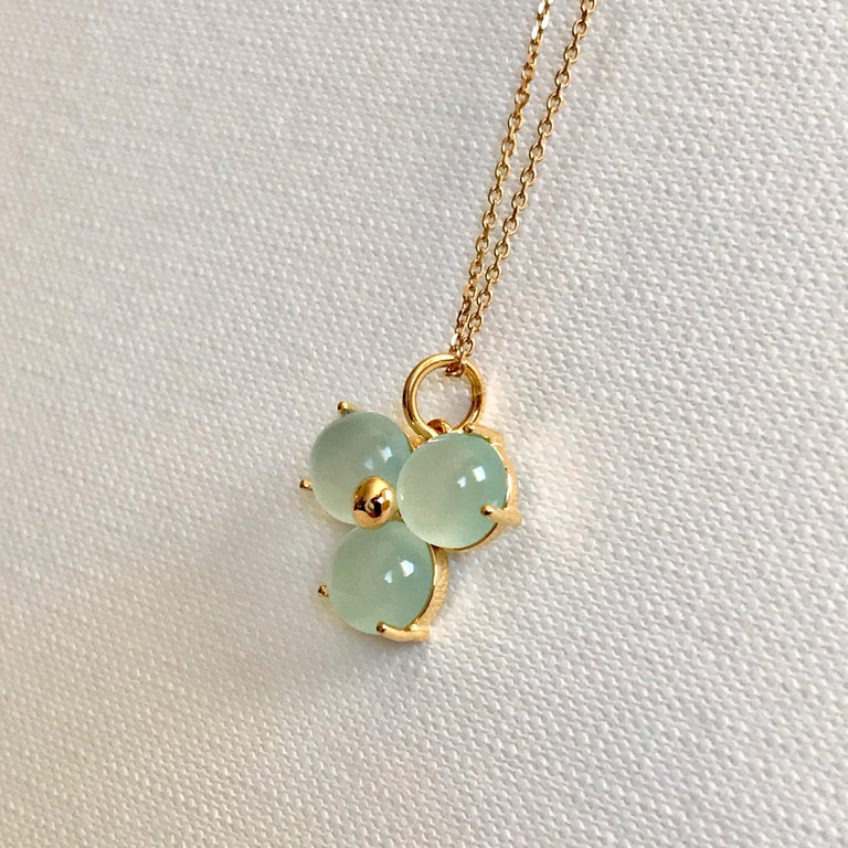 Handmade 18 Karat solid yellow gold blossom pendant necklace with light blue round cabochon cut chalcedony stones.
The chain can also be used with other pendants or just by itself. 
Hallmark: London Goldsmiths’ Company – Assay Office
Pendant's